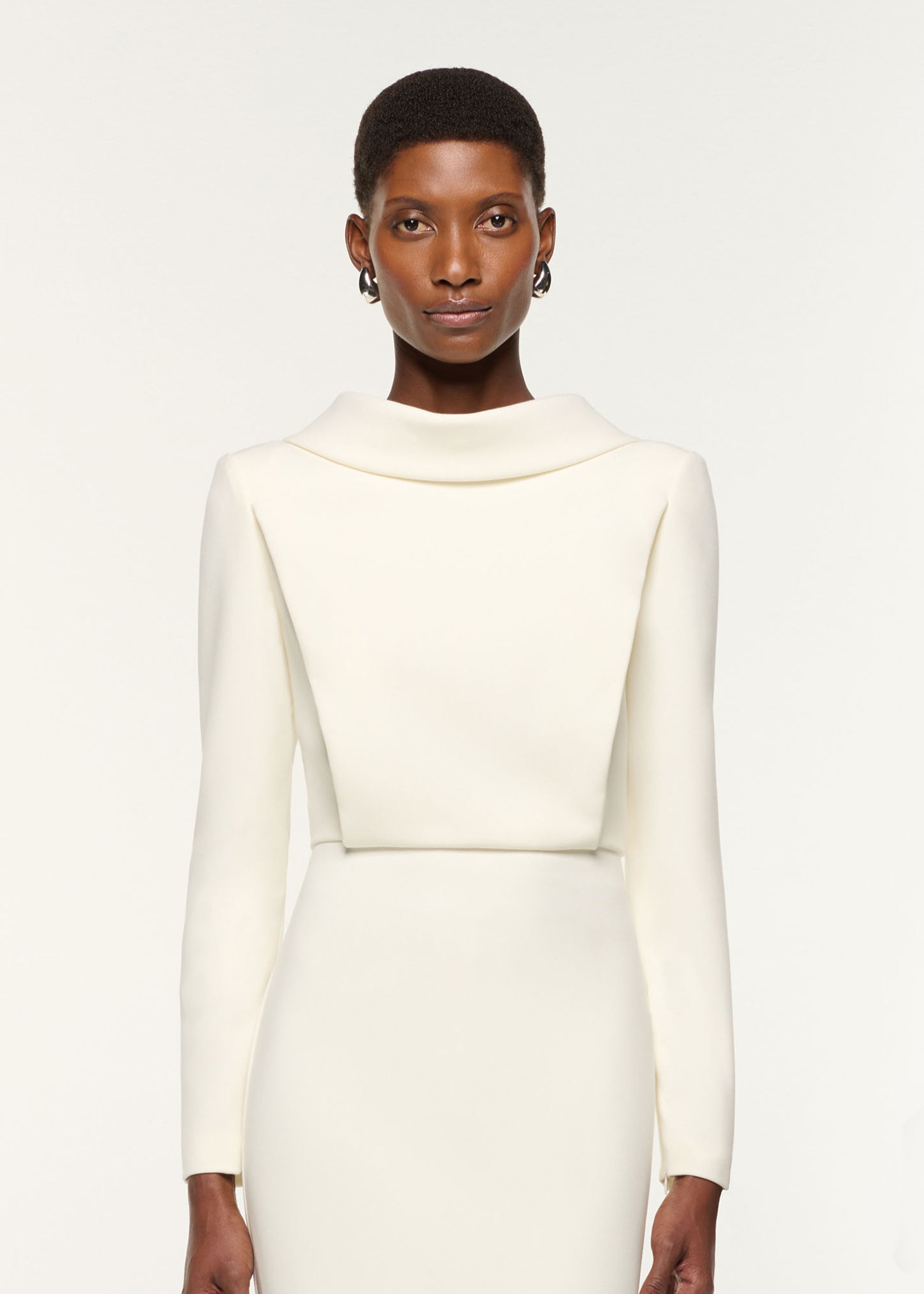 Close up of a model wearing the Collared Crepe Midi Dress in Cream