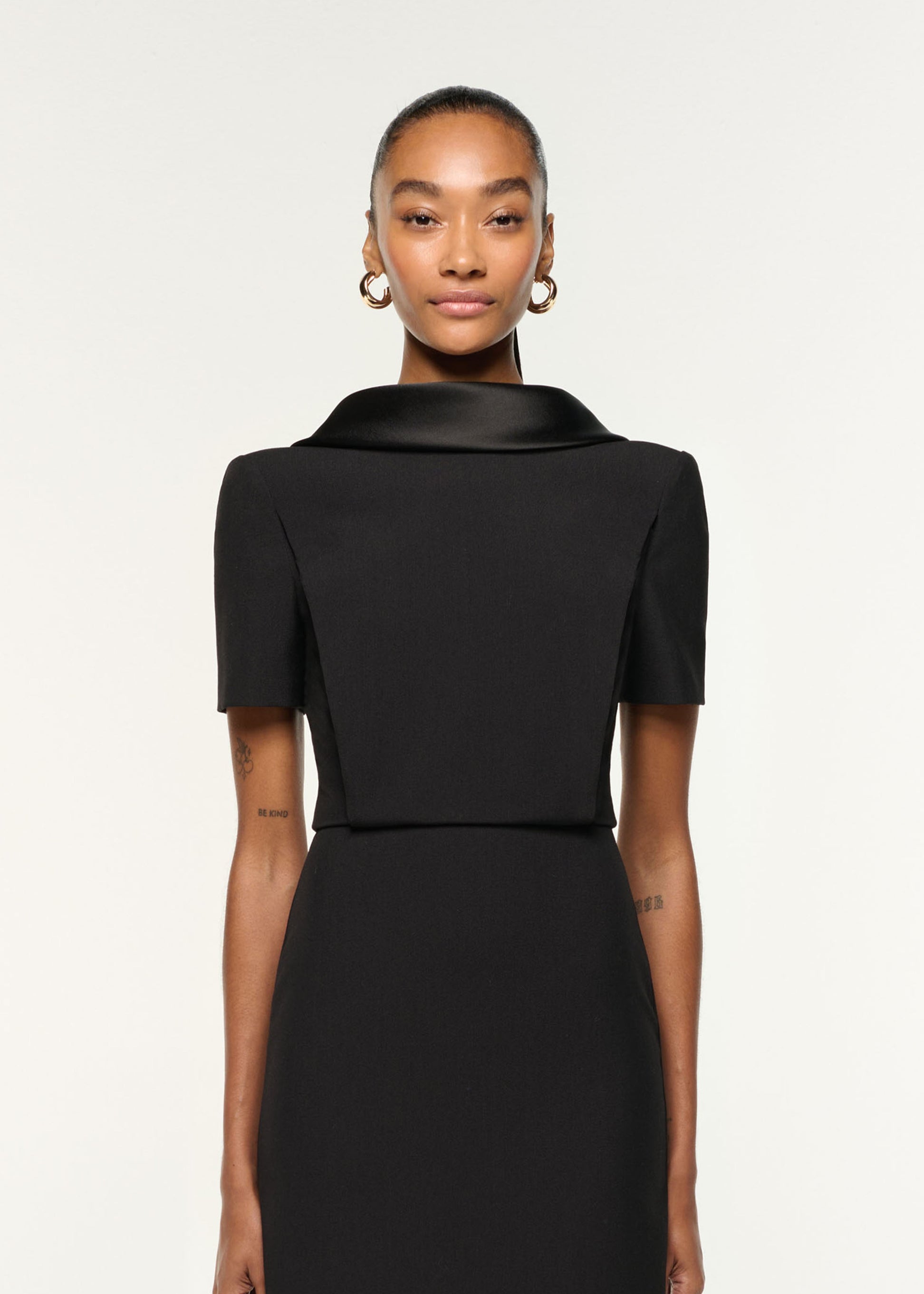 Close up of a model wearing the Collared Crepe Midi Dress in Black