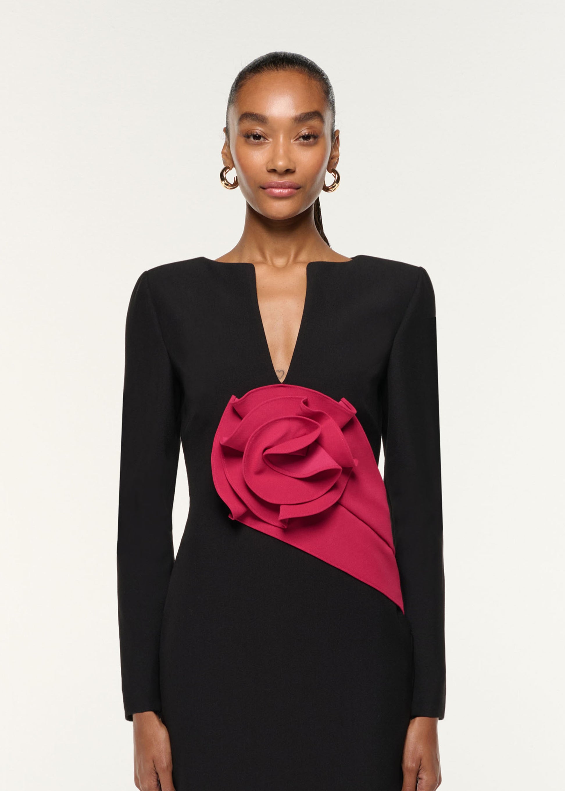 Close up of a model wearing the Flower Drape Crepe Gown in Black