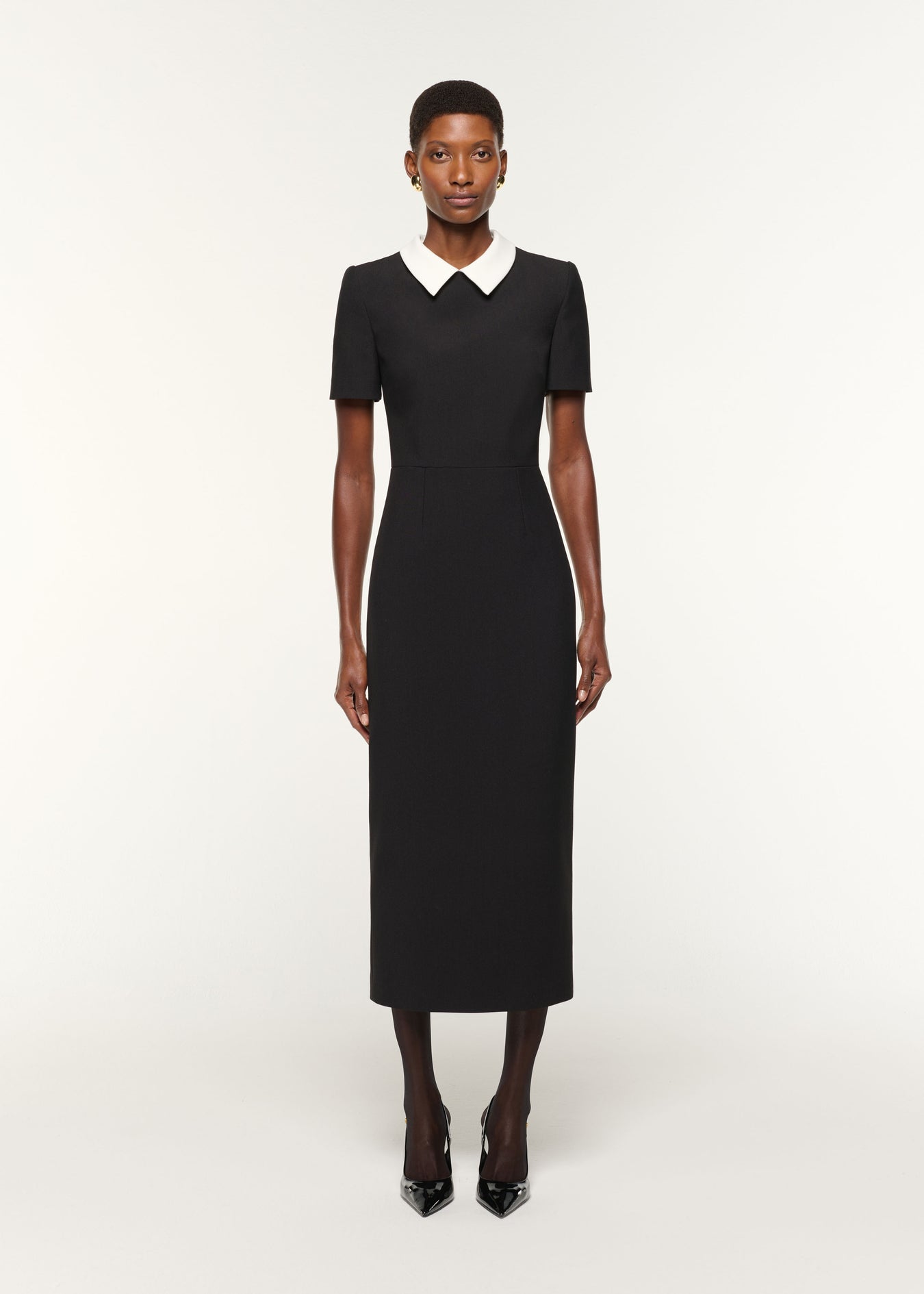 Front view of a model wearing the Contrast Collar Crepe Midi Dress in Black
