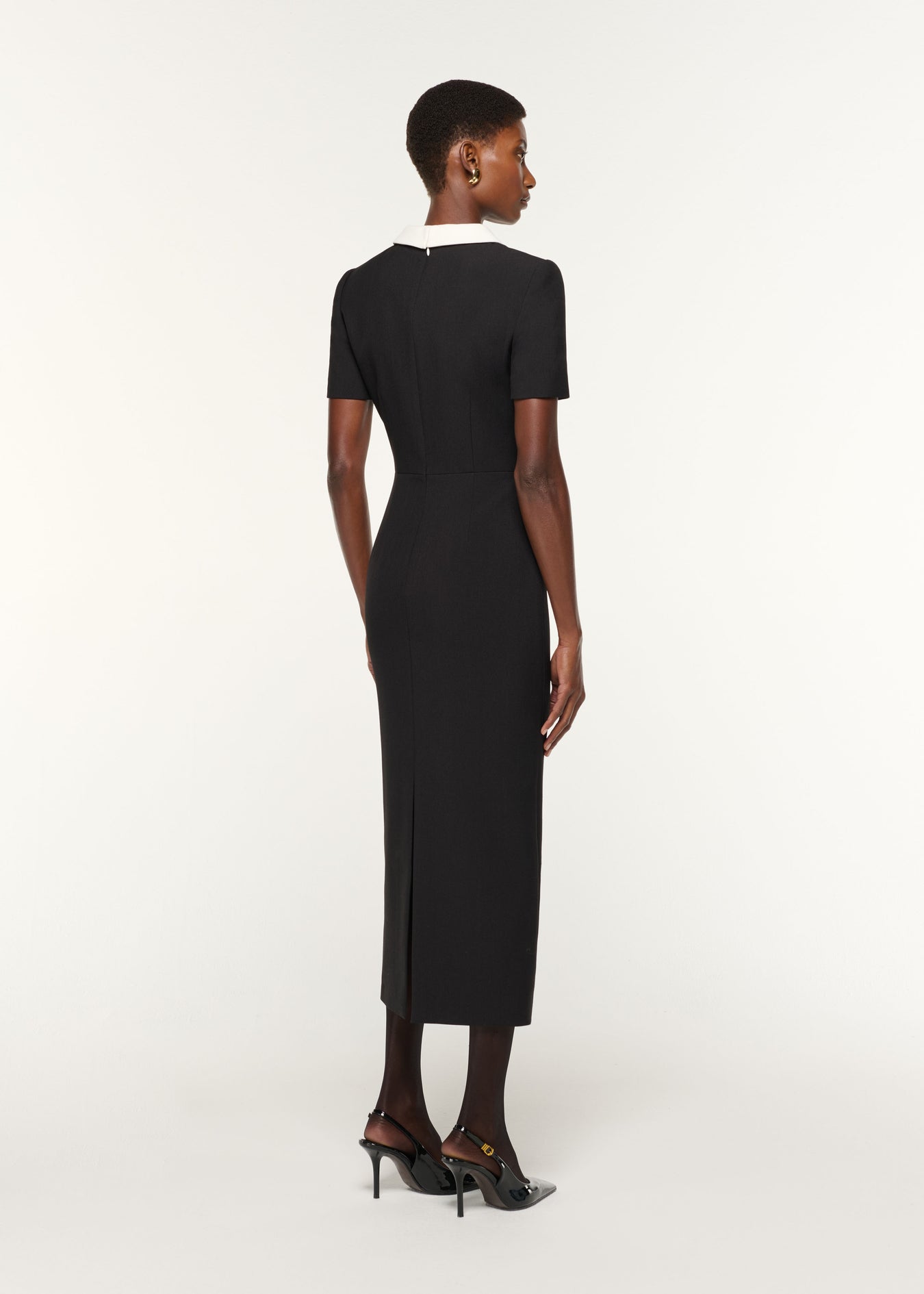 Back view of a model wearing the Contrast Collar Crepe Midi Dress in Black