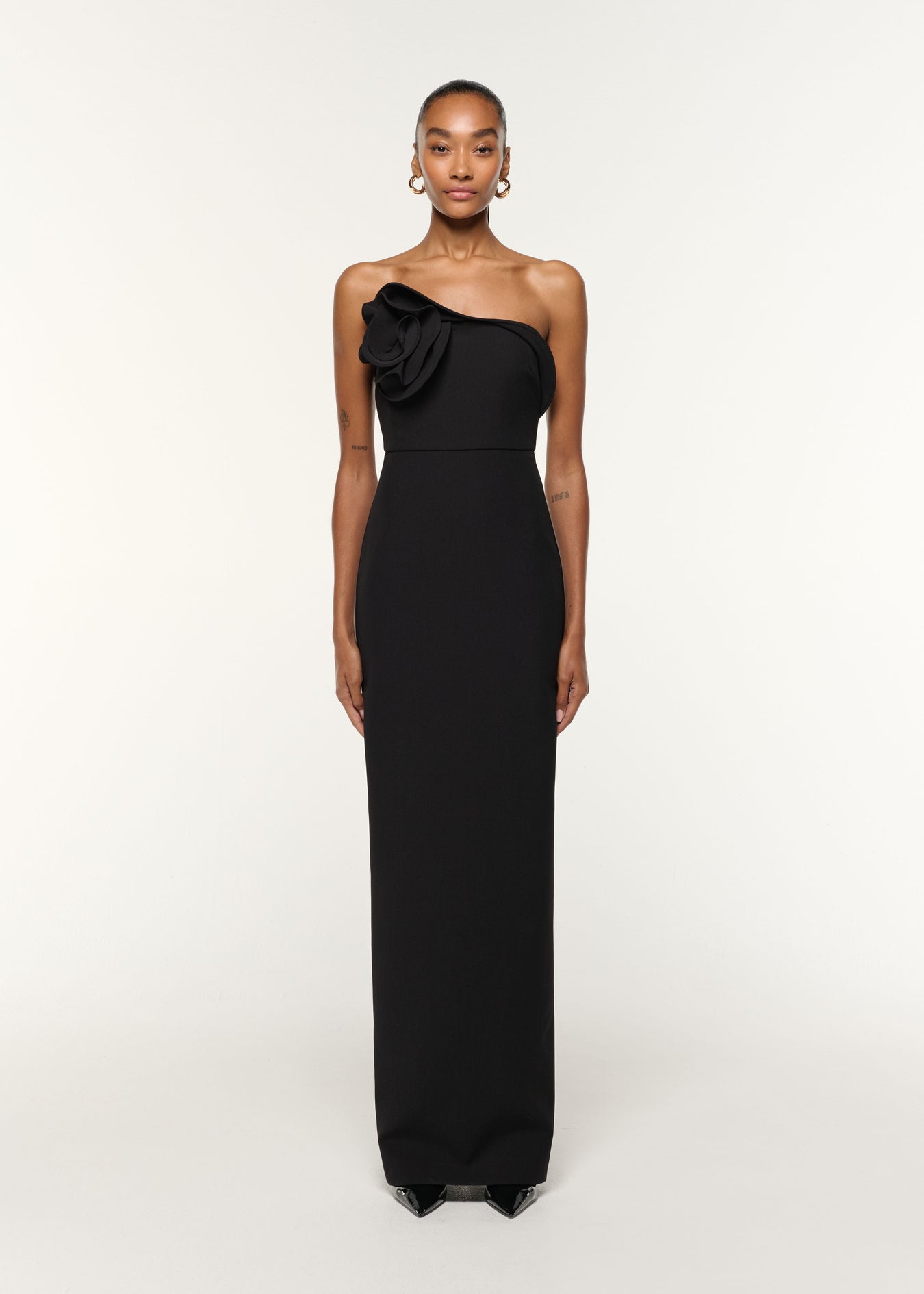 Front view of a model wearing the Flower Detail Strapless Gown in Black