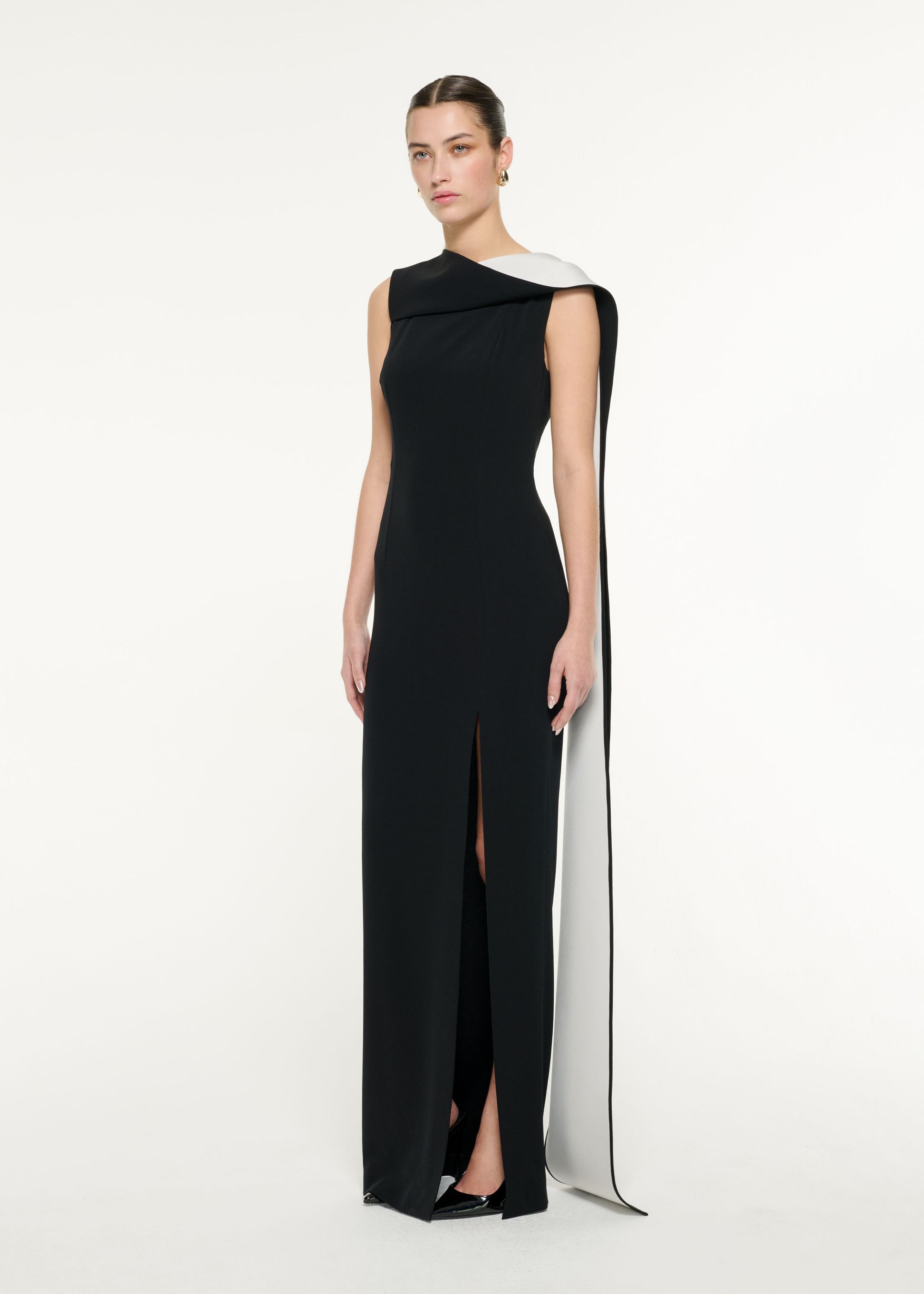 Side view of a model wearing the Satin Crepe Sash Gown in Monochrome