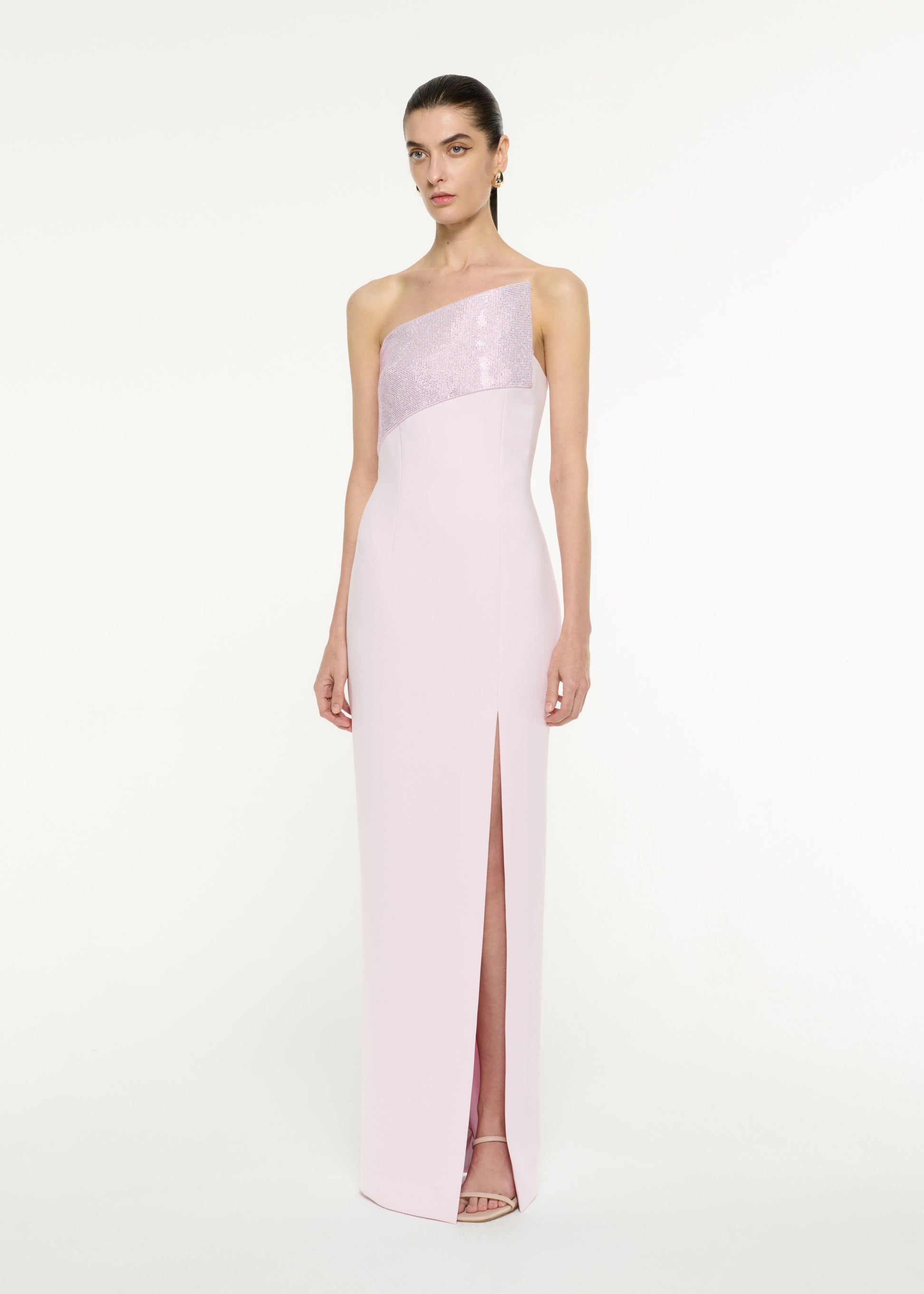 Side view of a model wearing the Asymmetric Diamante Panel Gown in Light Pink