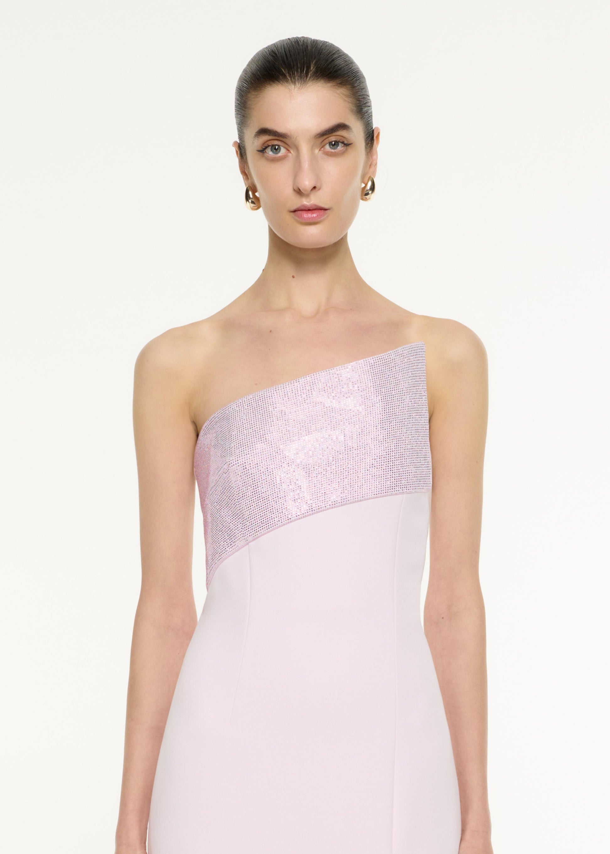 Close up of a model wearing the Asymmetric Diamante Panel Gown in Light Pink