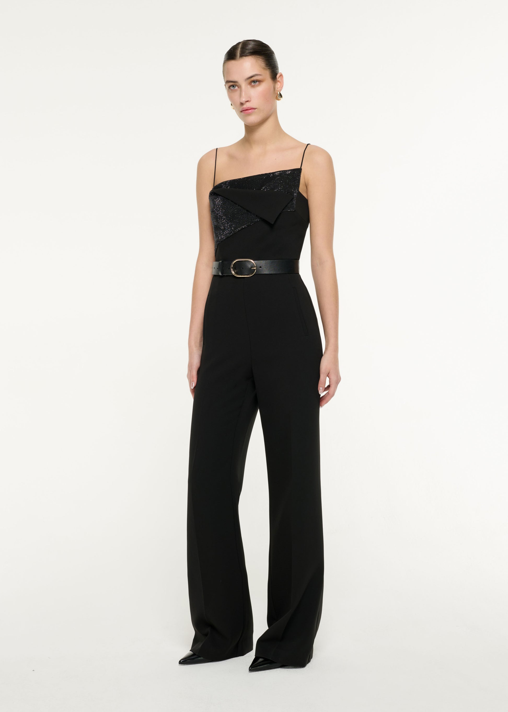 Side view of a model wearing the Diamante Panel Jumpsuit in Black