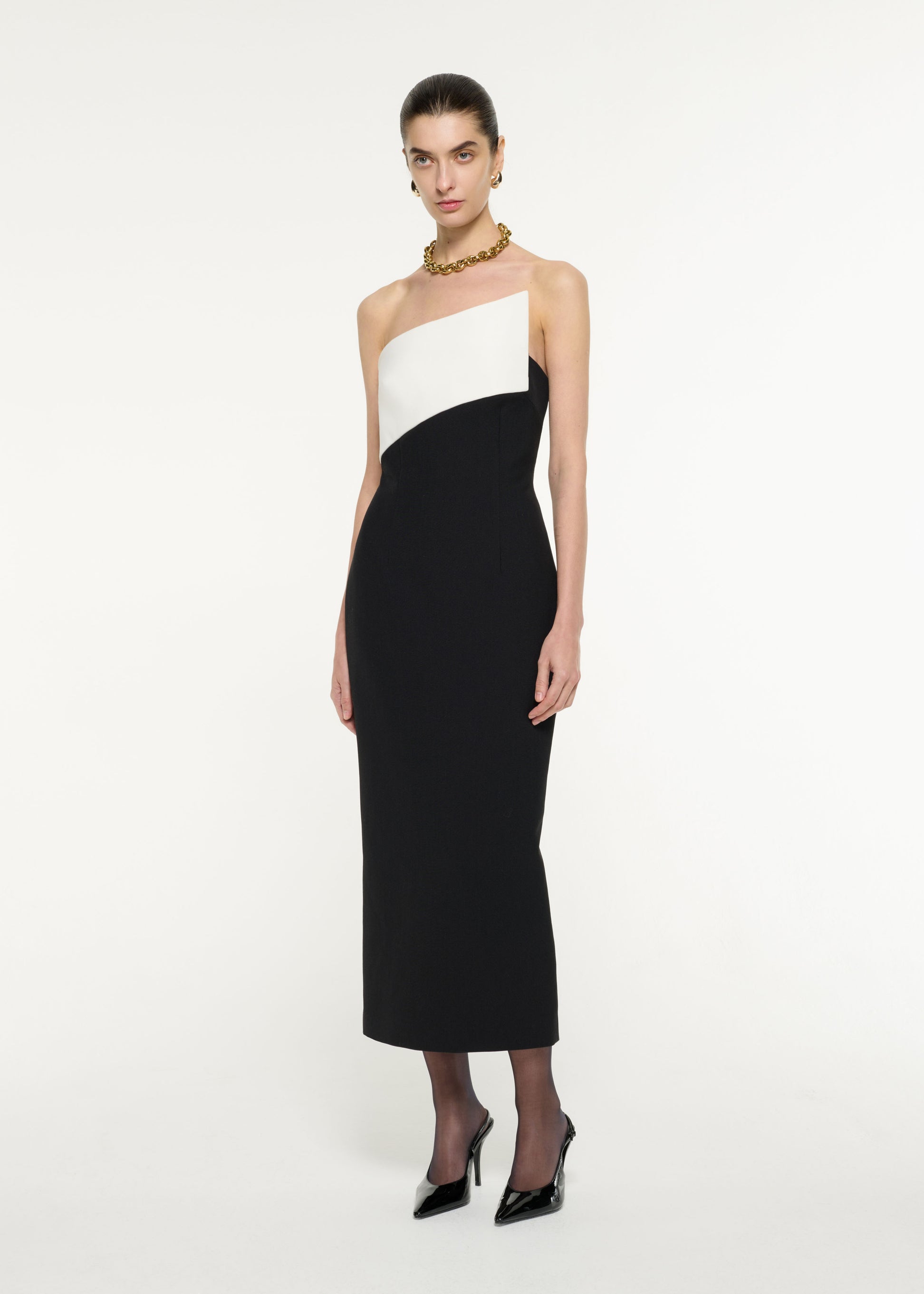 Side view of a model wearing the Contrast Panel Midi Dress in Monochrome
