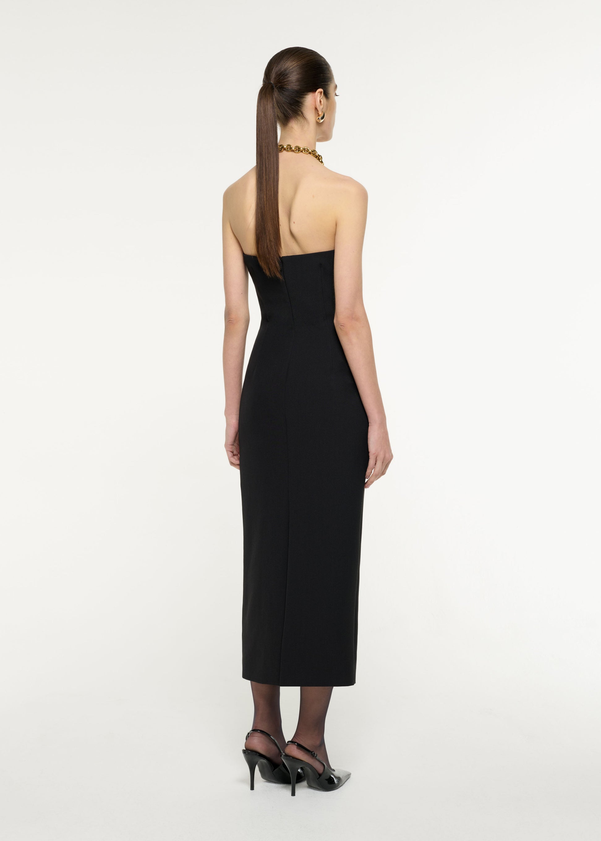 Back view of a model wearing the Contrast Panel Midi Dress in Monochrome