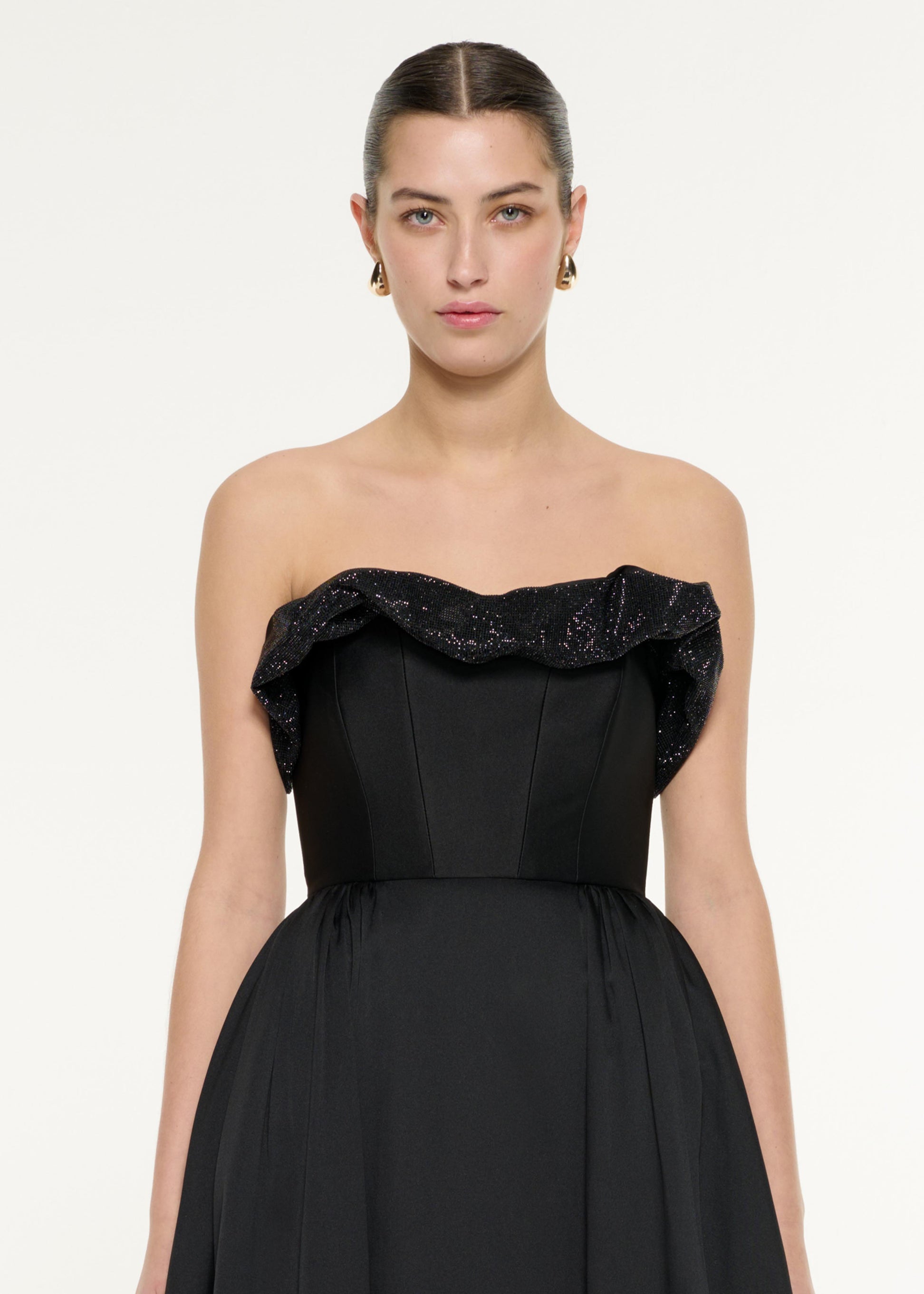 Close up of a model wearing the Ruffle Taffeta Gown in Black