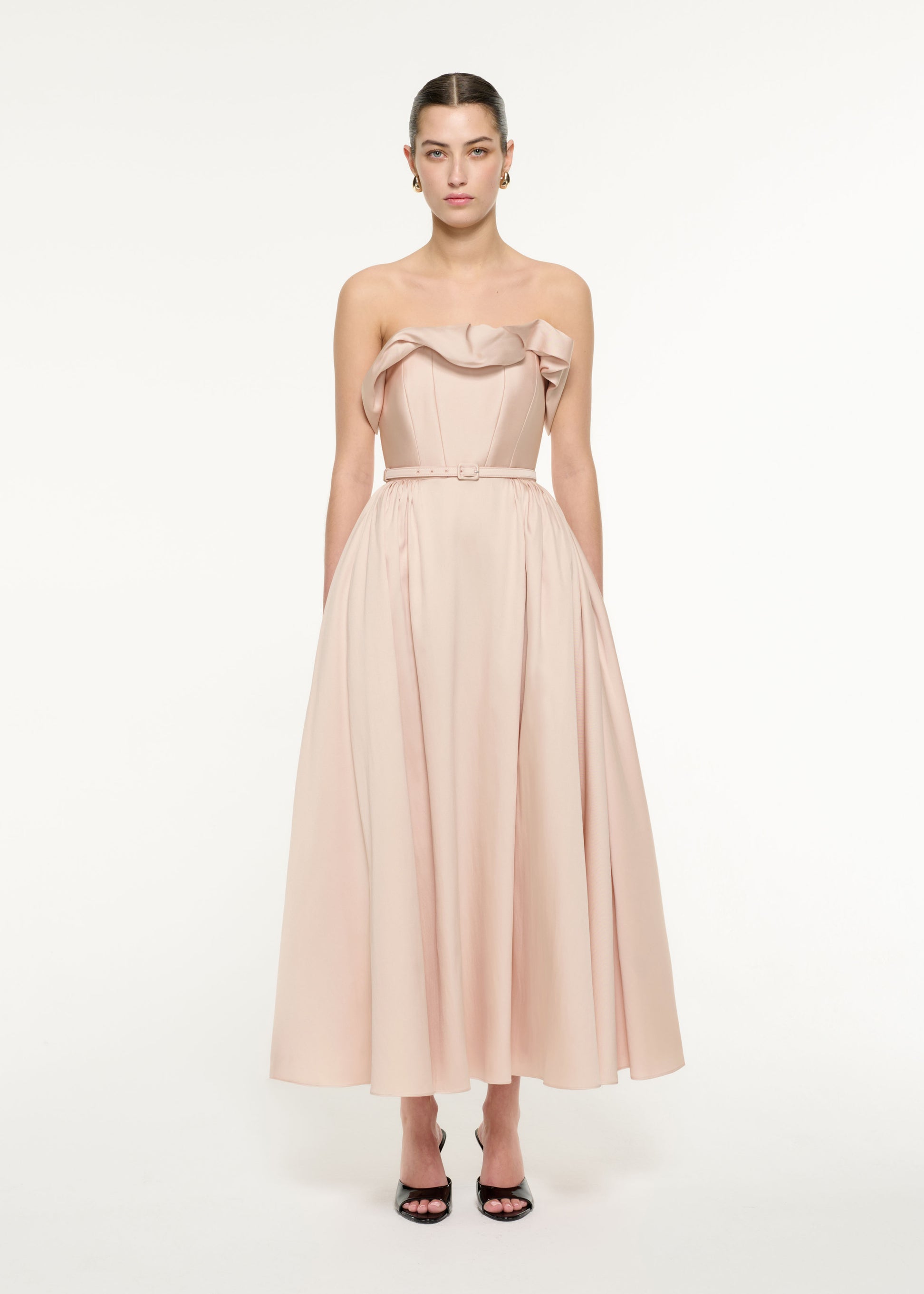 Front view of a model wearing the Ruffle Midi Dress in Nude