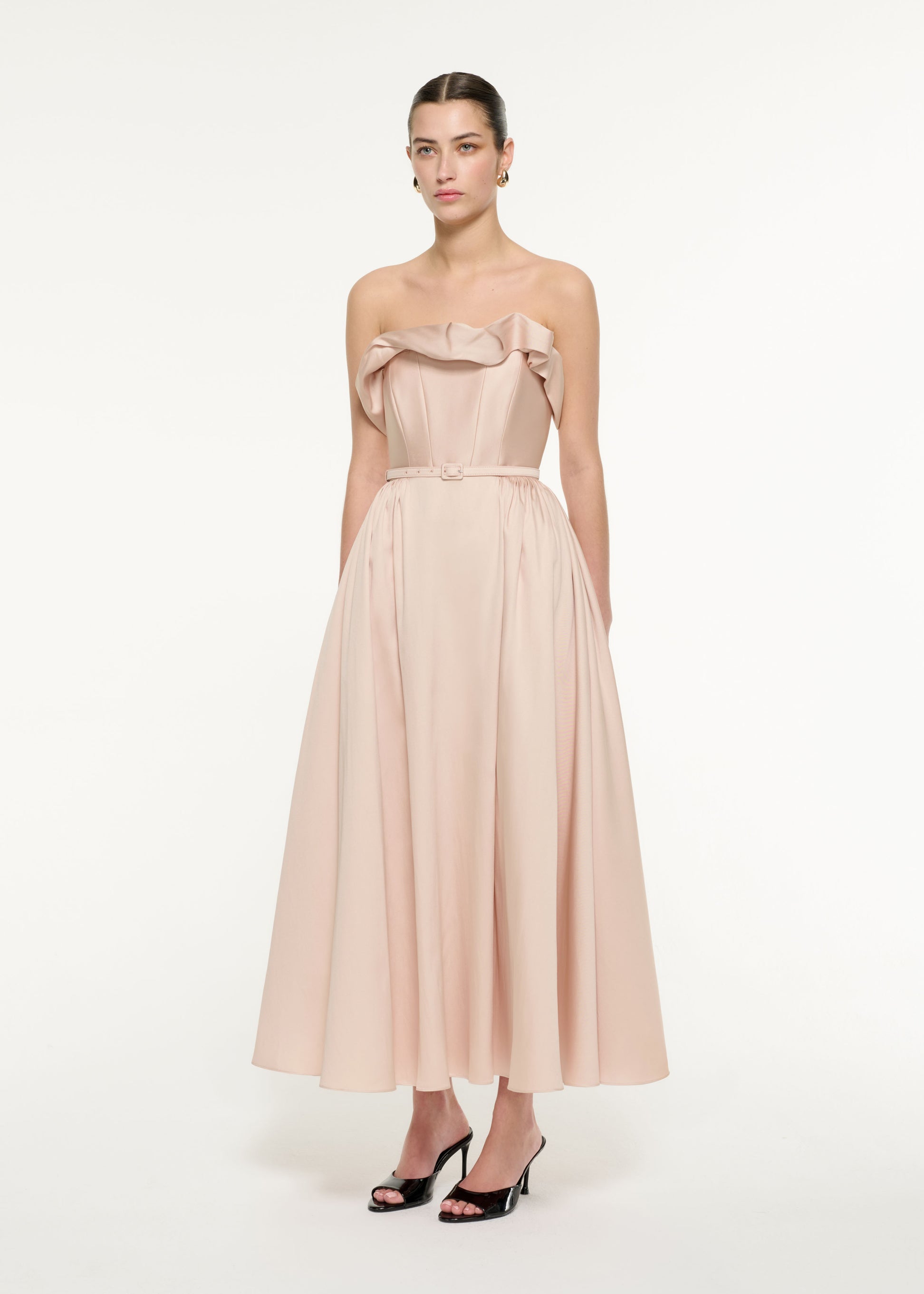 Side view of a model wearing the Ruffle Midi Dress in Nude