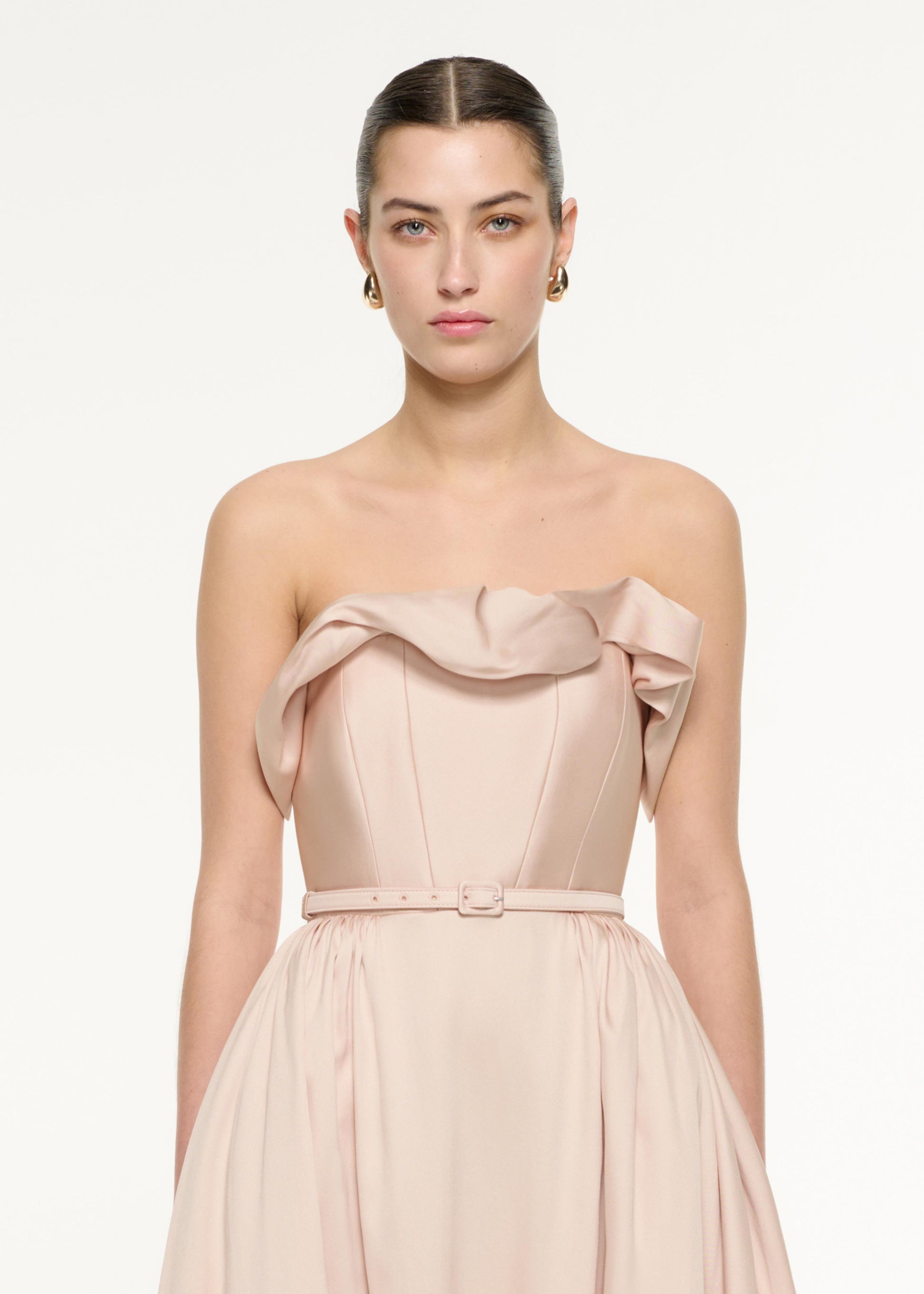 Close up of a model wearing the Ruffle Midi Dress in Nude