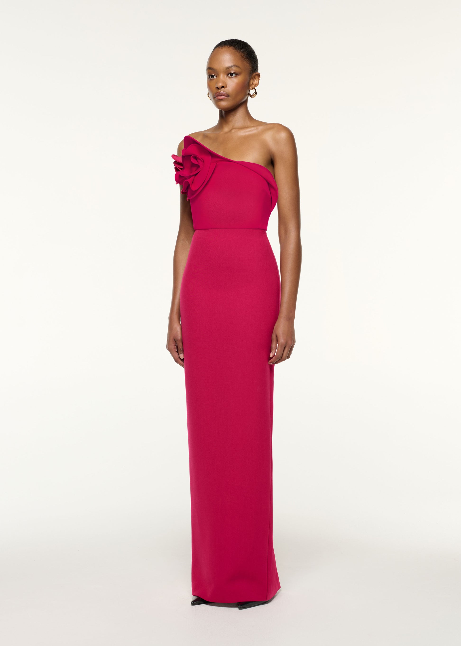 Side view of a model wearing the Flower Detail Strapless Evening Gown in Hot Pink
