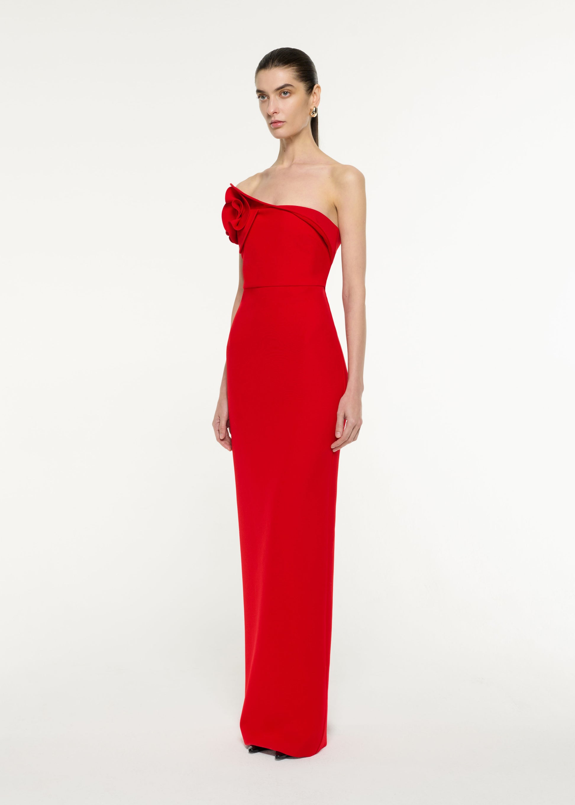 Side view of a model wearing the Flower Drape Crepe Gown in Red