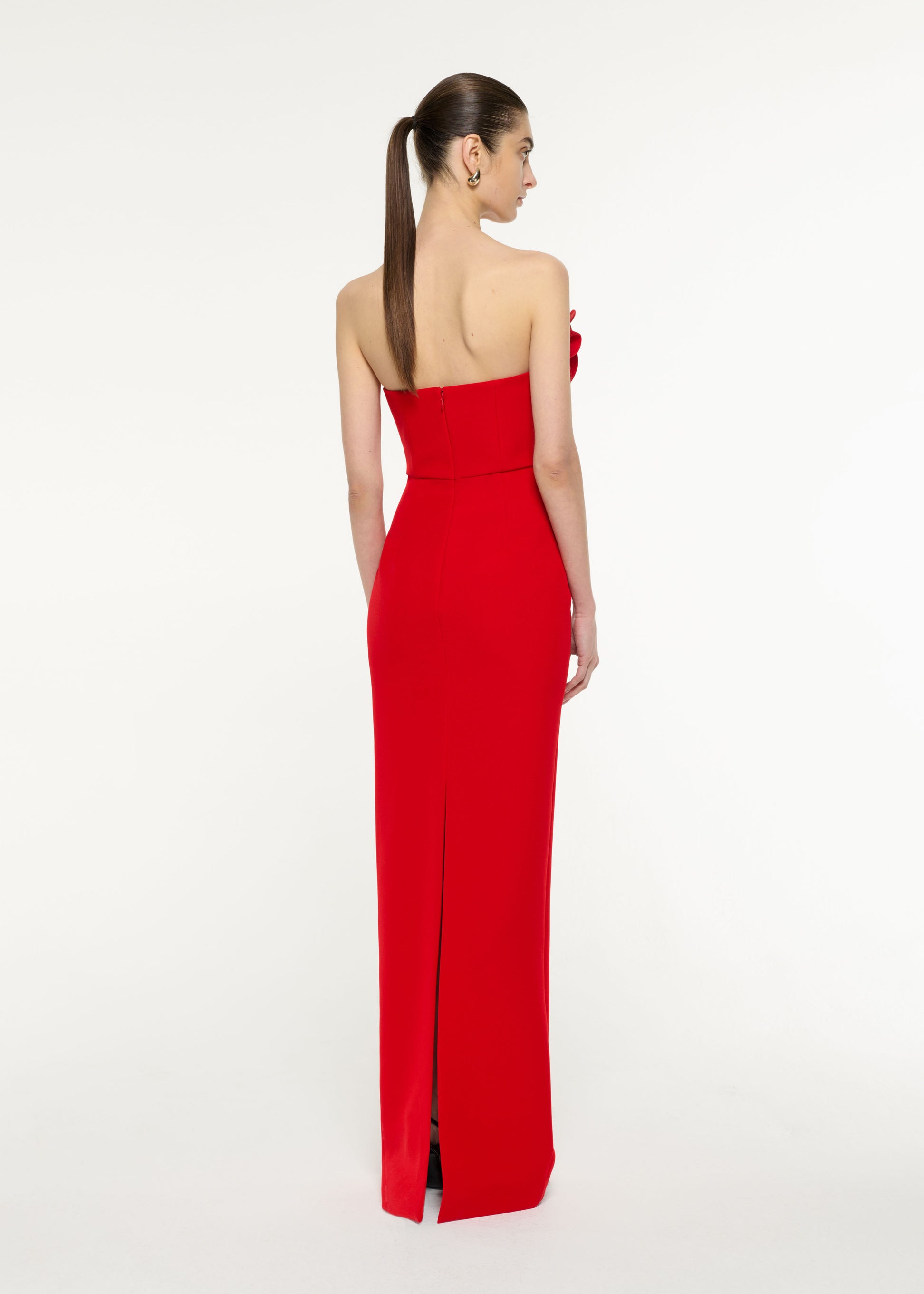 Back view of a model wearing the Flower Drape Crepe Gown in Red