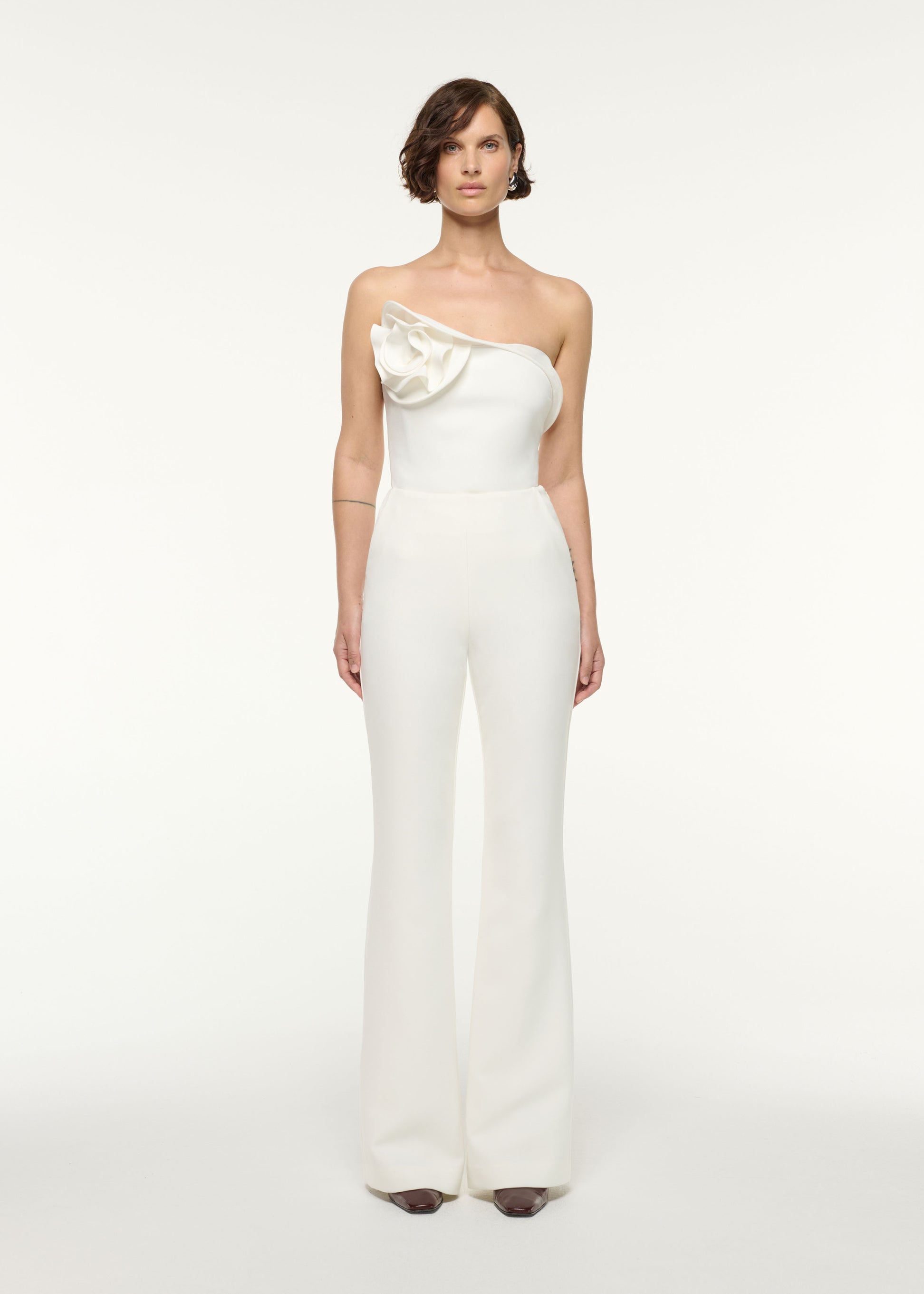 Front view of a model wearing the Flower Detail Strapless Top in White