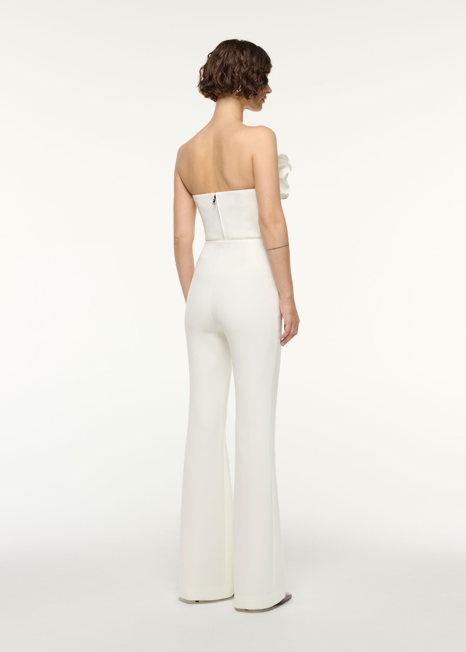 Back view of a model wearing the Flower Detail Strapless Top in White