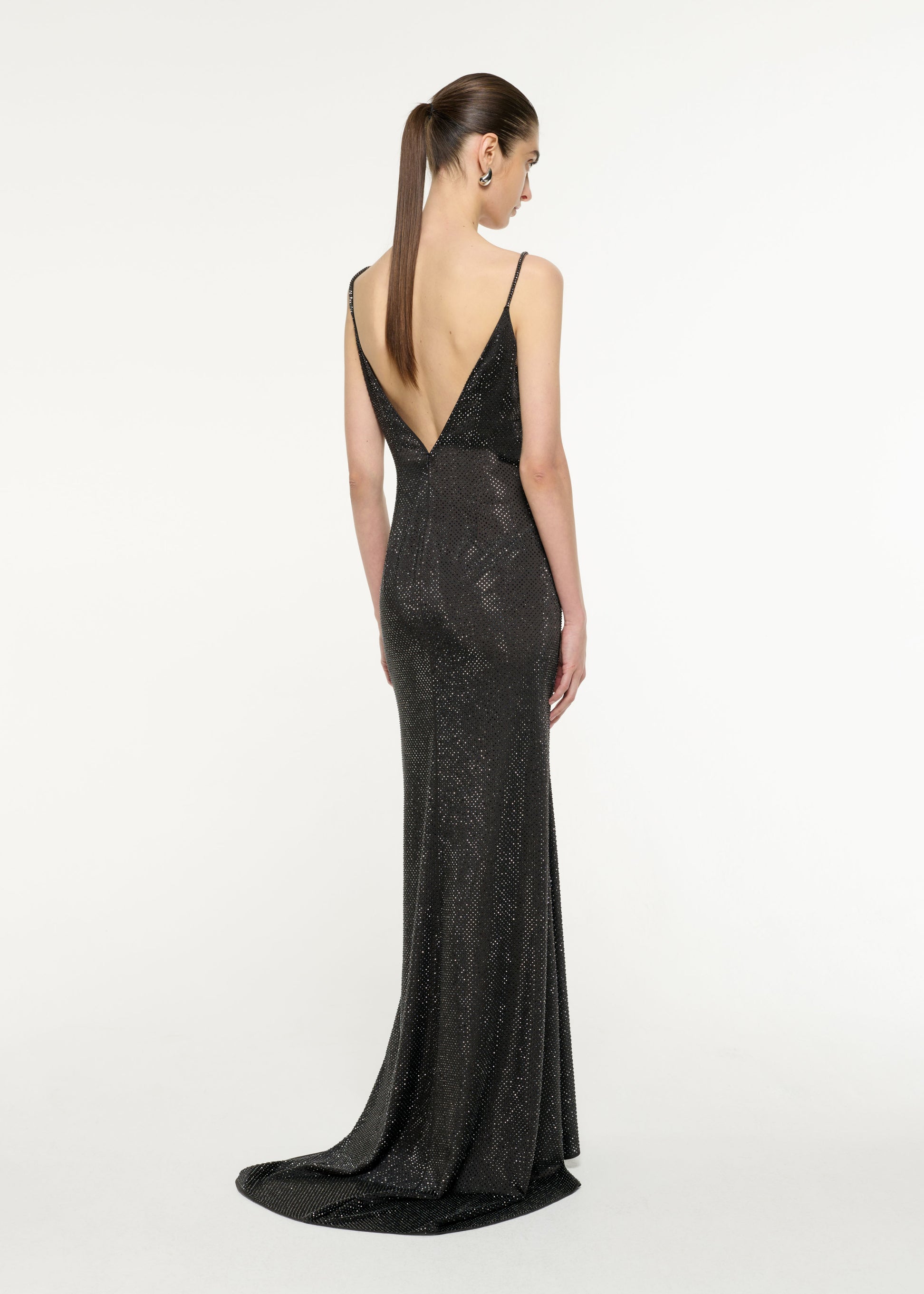 Back view of a model wearing the Satin Diamante Gown in Black