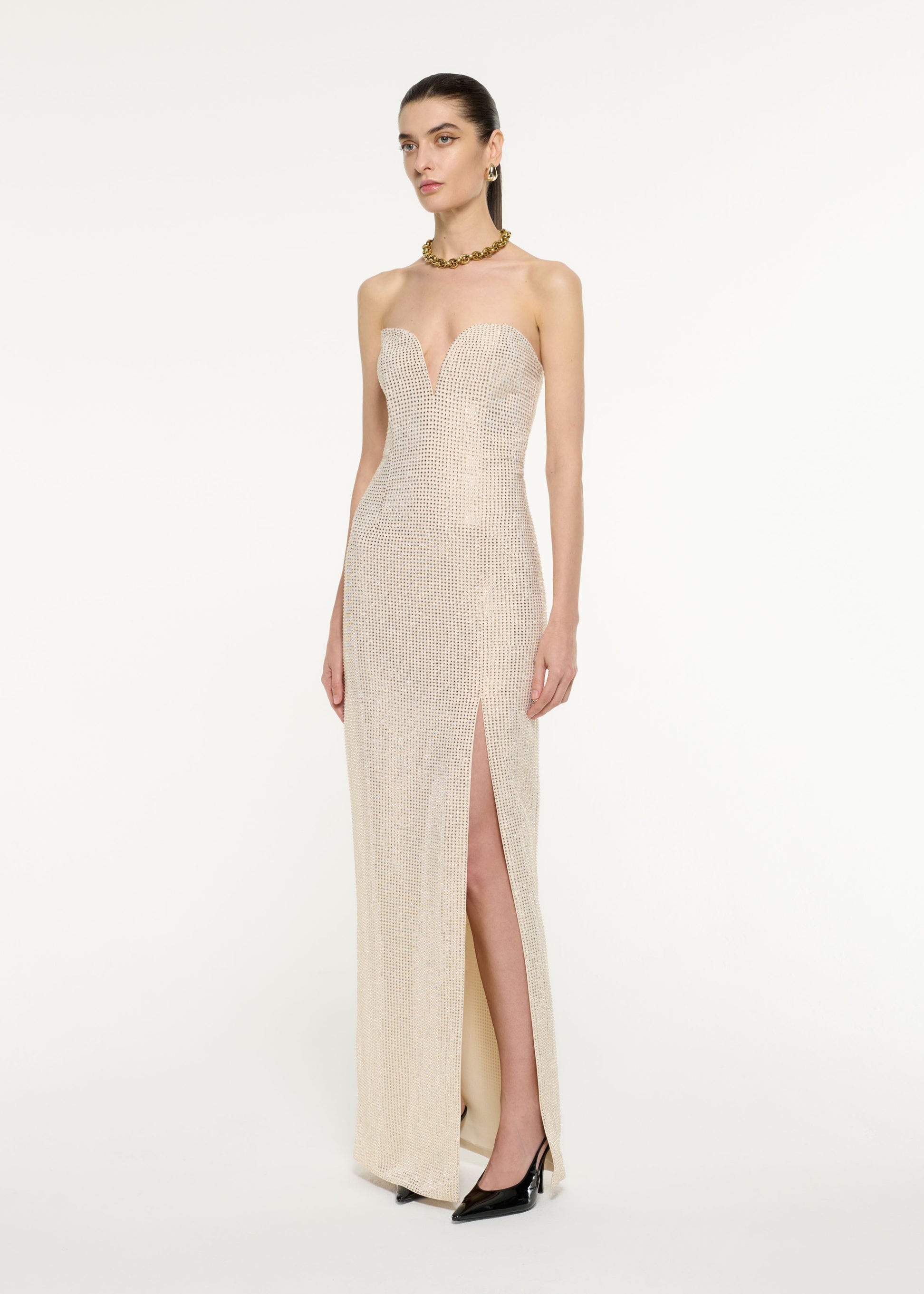 Side view of a model wearing the Diamante Embellished Gown in Champagne