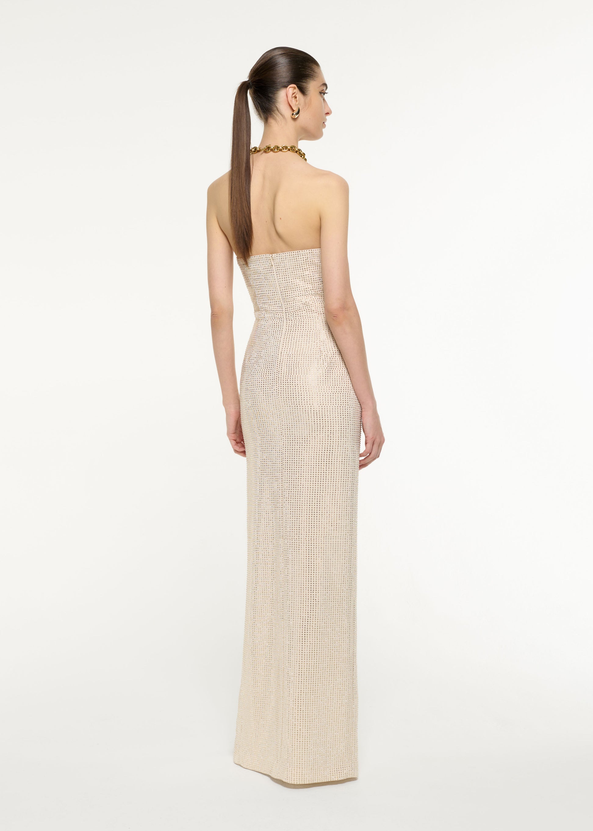 Back view of a model wearing the Diamante Embellished Gown in Champagne