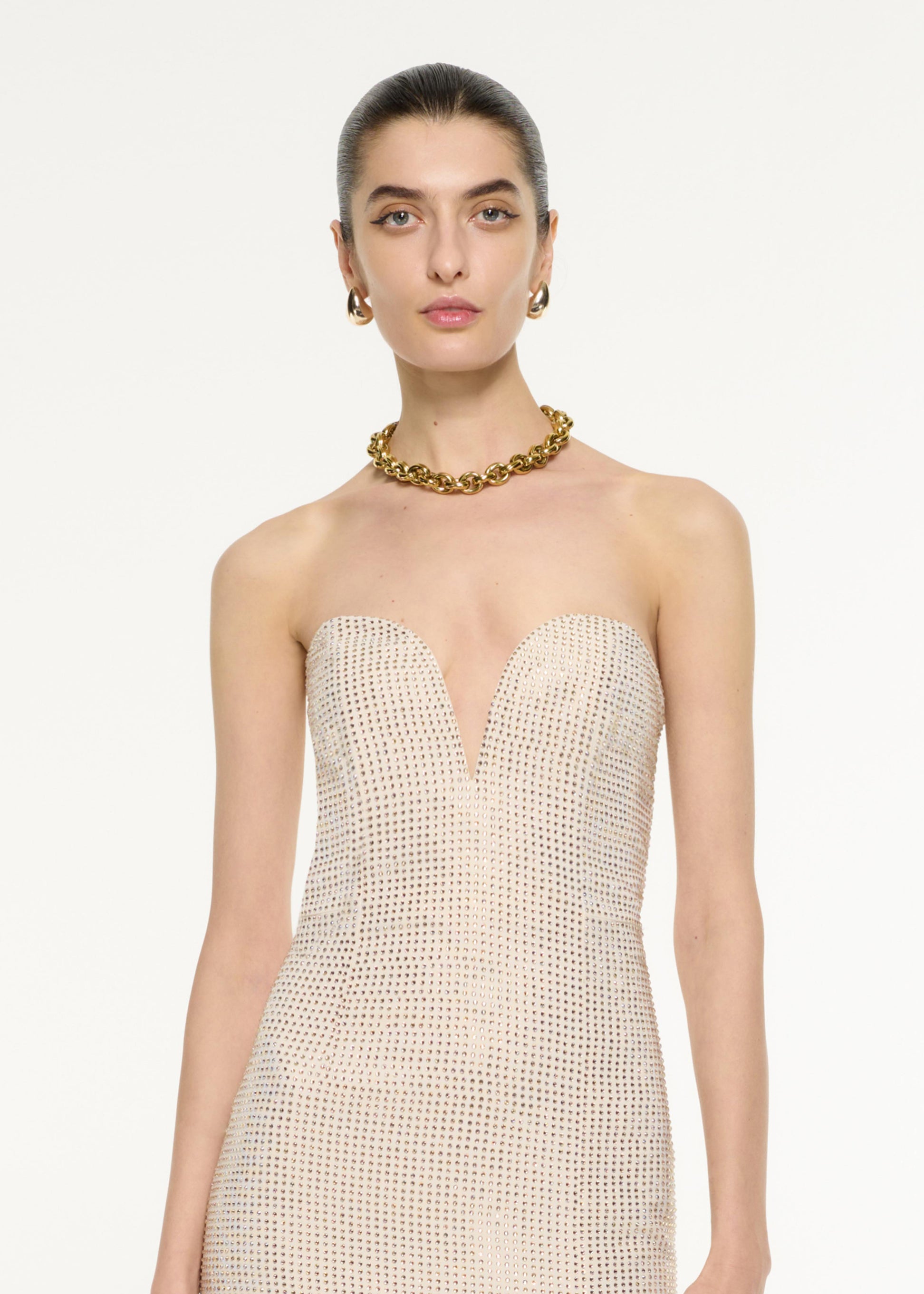 Close up of a model wearing the Diamante Embellished Gown in Champagne