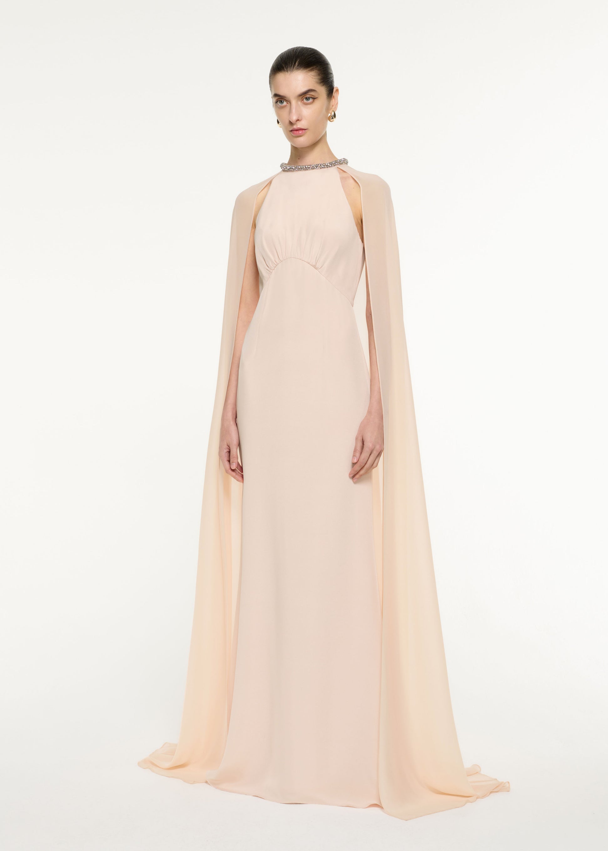 Side view of a model wearing the Silk Chiffon Cape Dress in Nude
