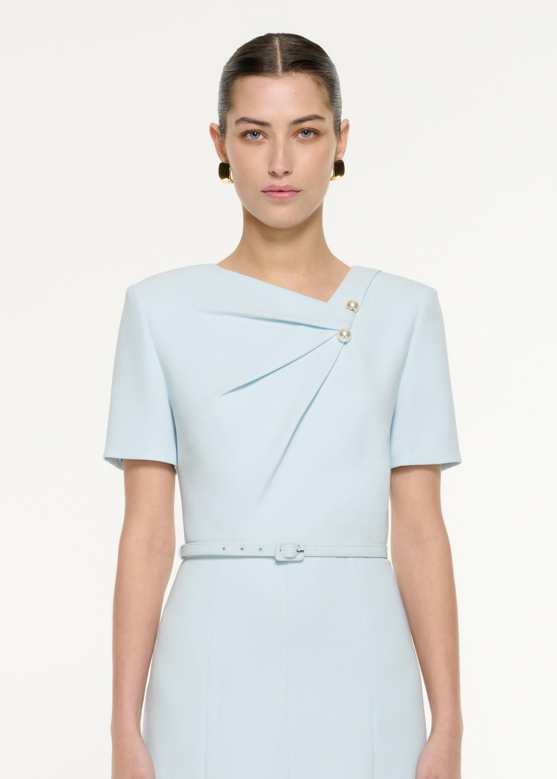 Close up of a model wearing the Tri-fold Belted Midi Dress in Blue