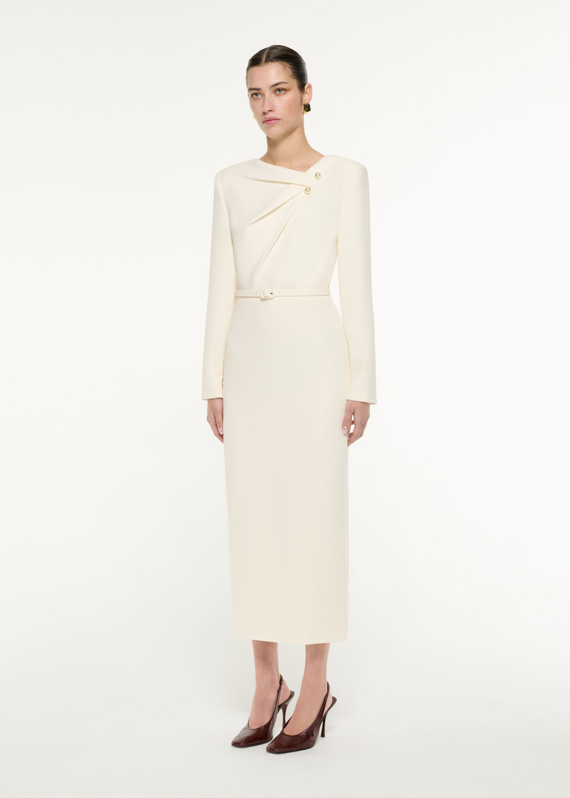 Side view of a model wearing the Tri-fold drape Midi Dress in Cream