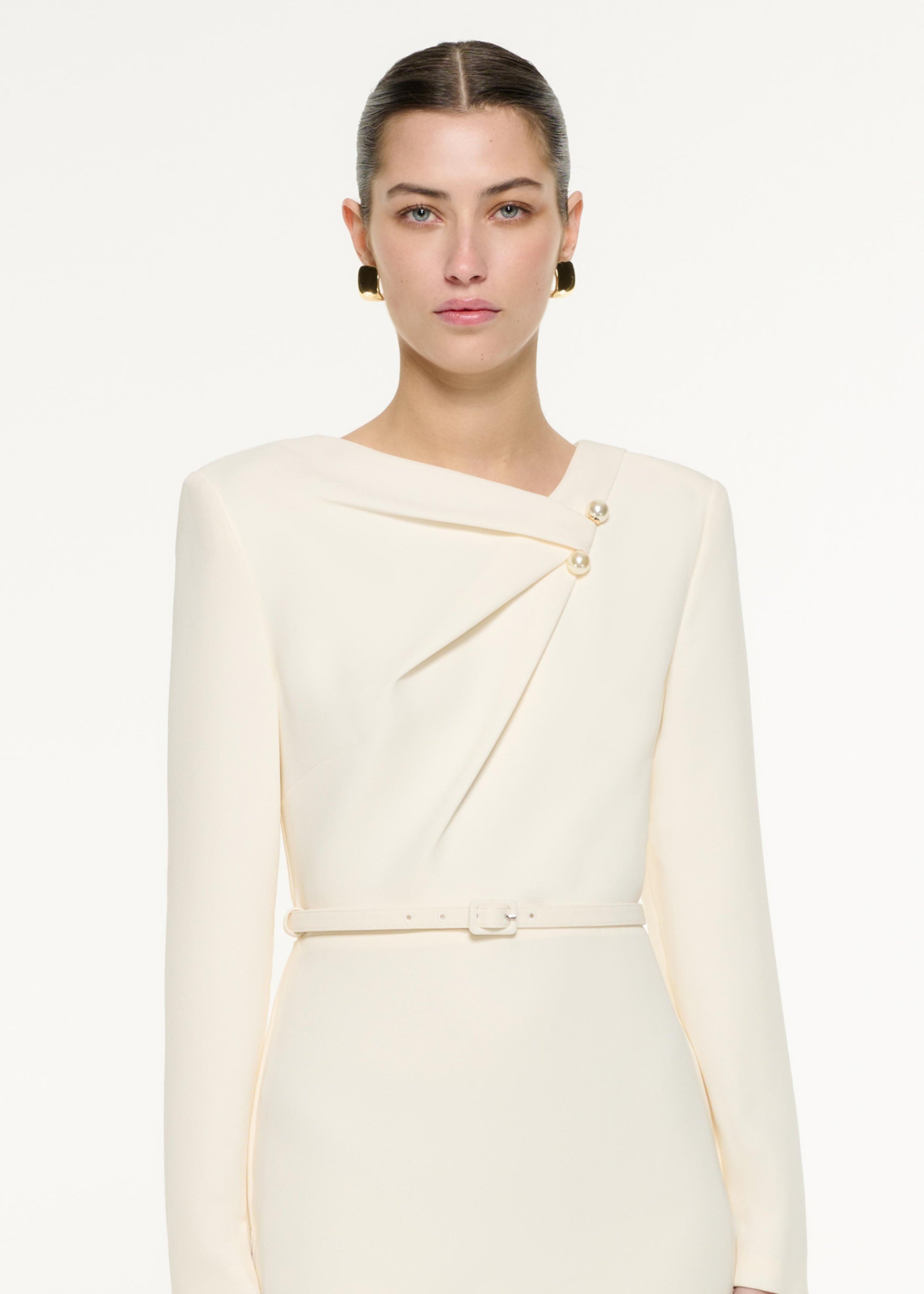 Close up of a model wearing the Tri-fold drape Midi Dress in Cream