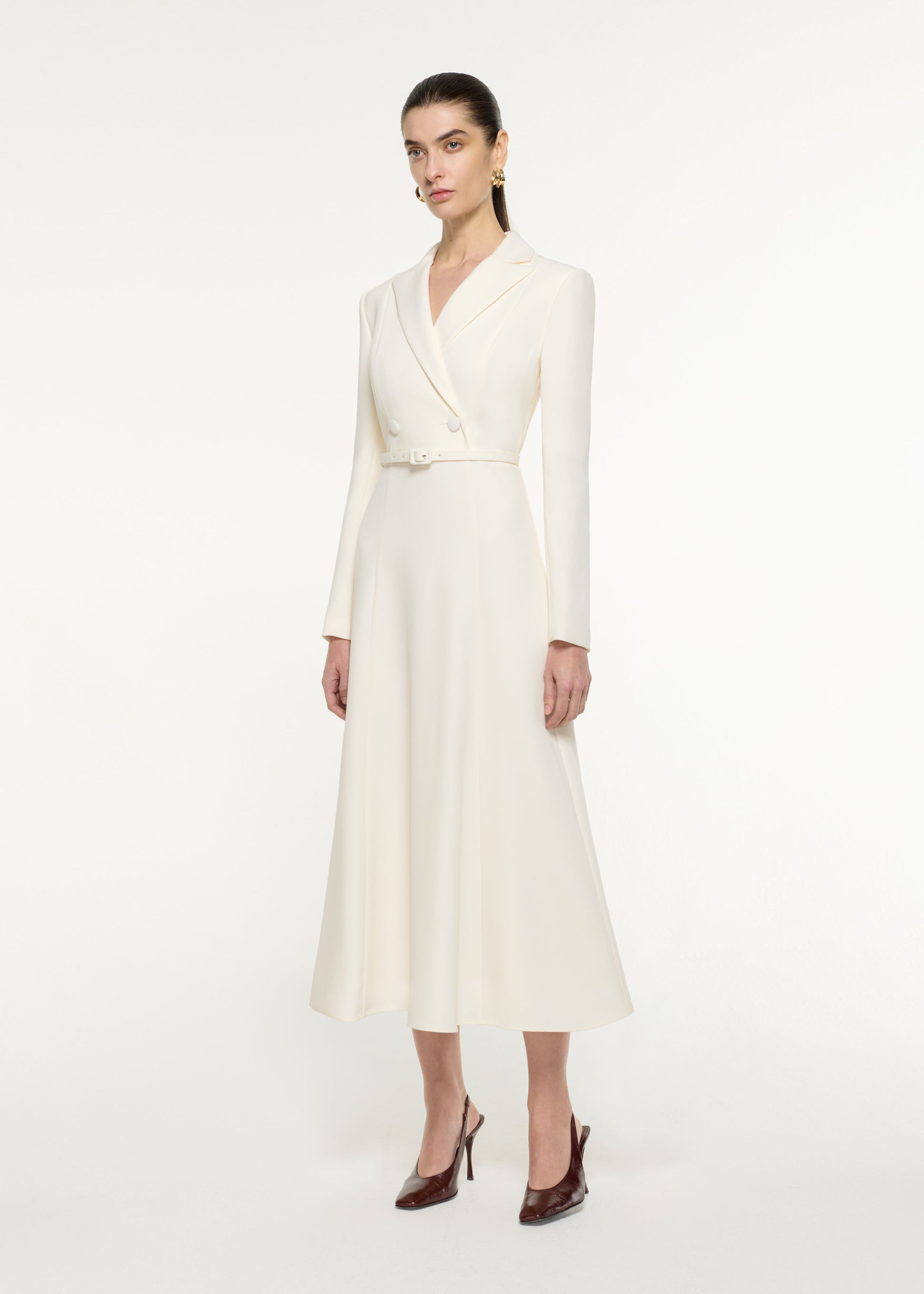 Side view of a model wearing the Tailored Midi Dress in Cream