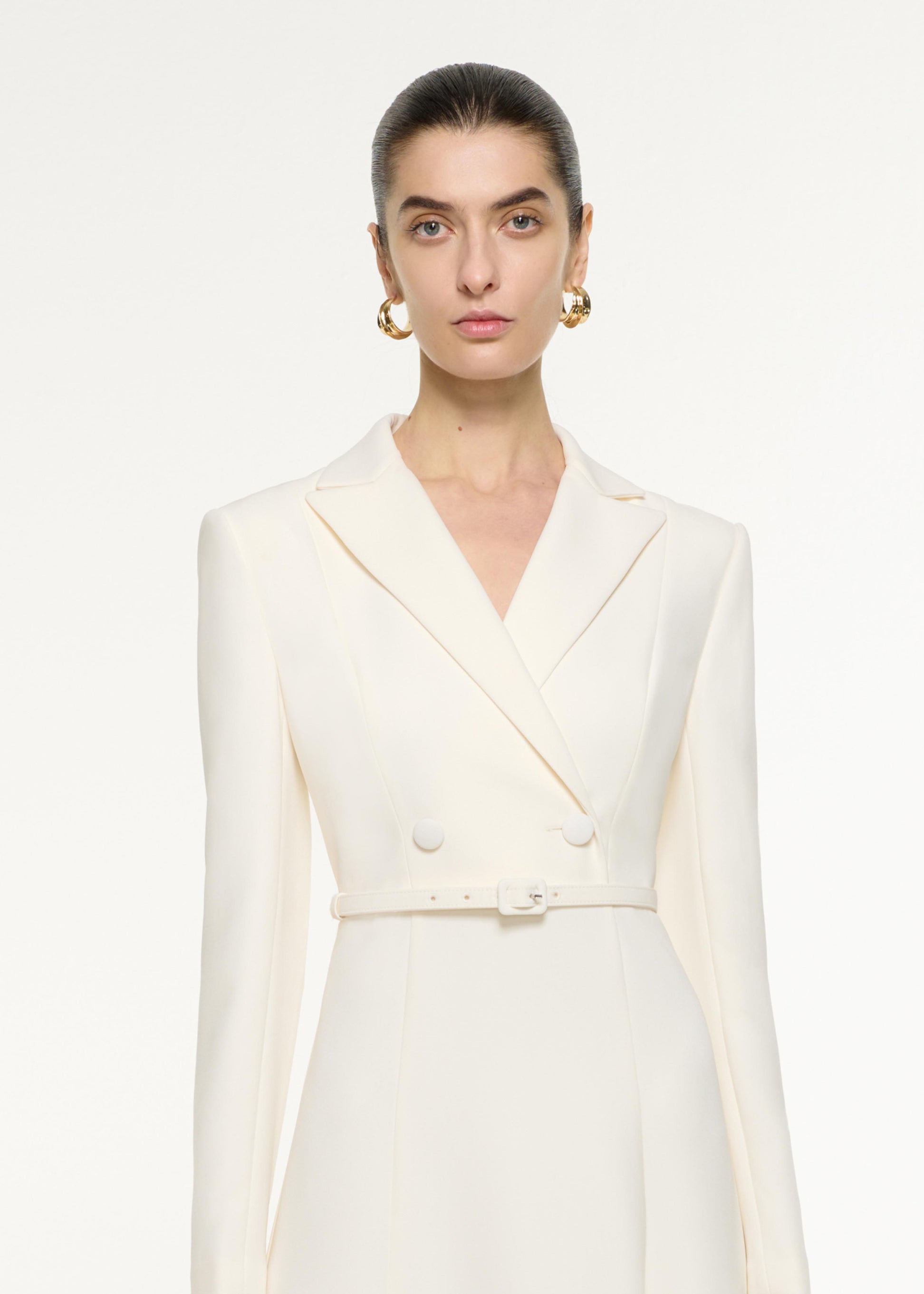 Close up of a model wearing the Tailored Midi Dress in Cream