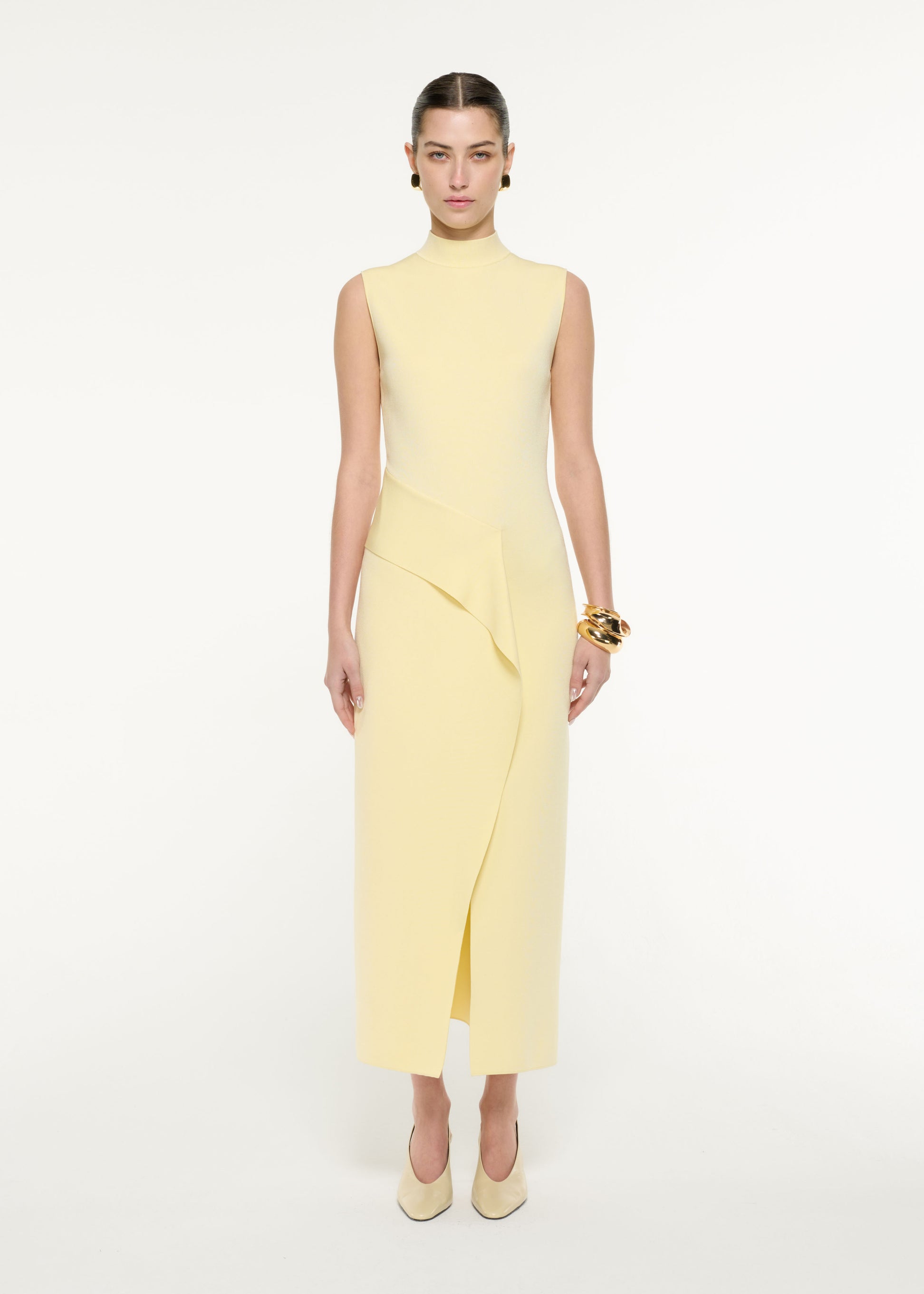 Side view of a model wearing the Flat Knit Drape Midi Dress in Yellow