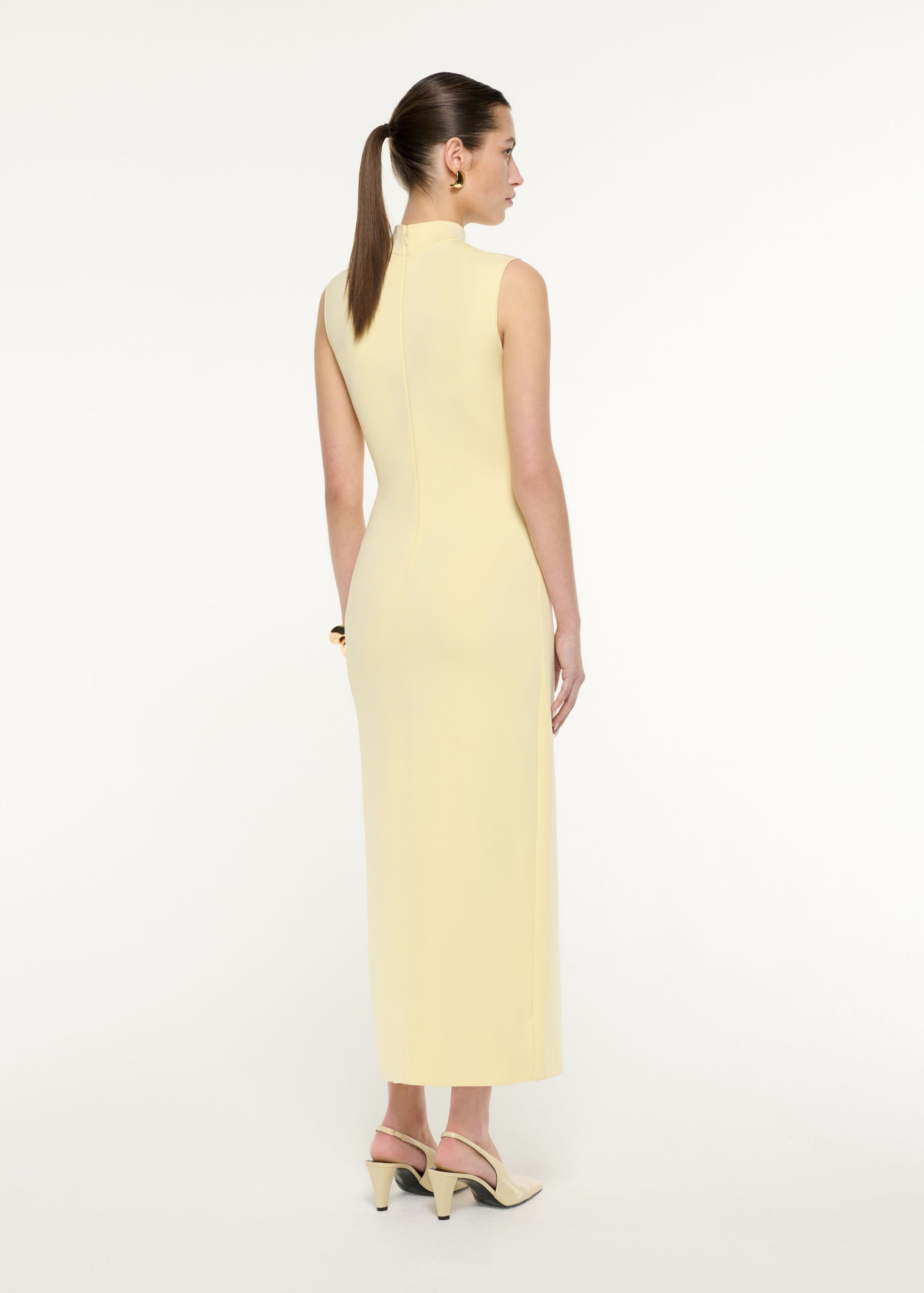 Back view of a model wearing the Flat Knit Drape Midi Dress in Yellow