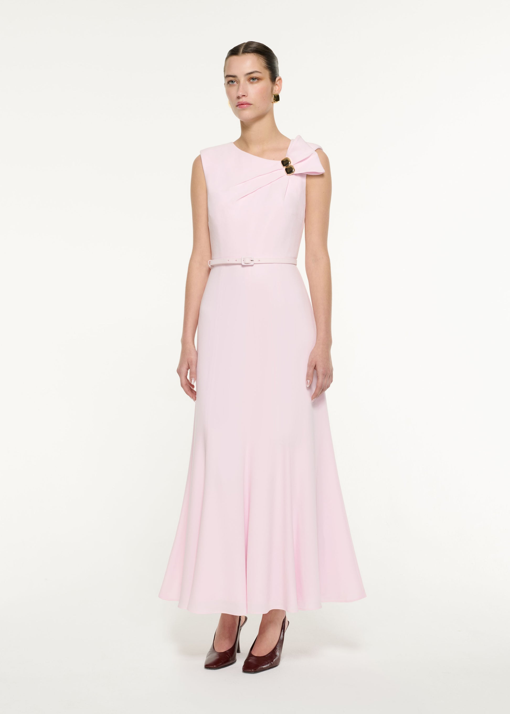 Side view of a model wearing the Bow Drape Satin Crepe Maxi Dress in Light Pink