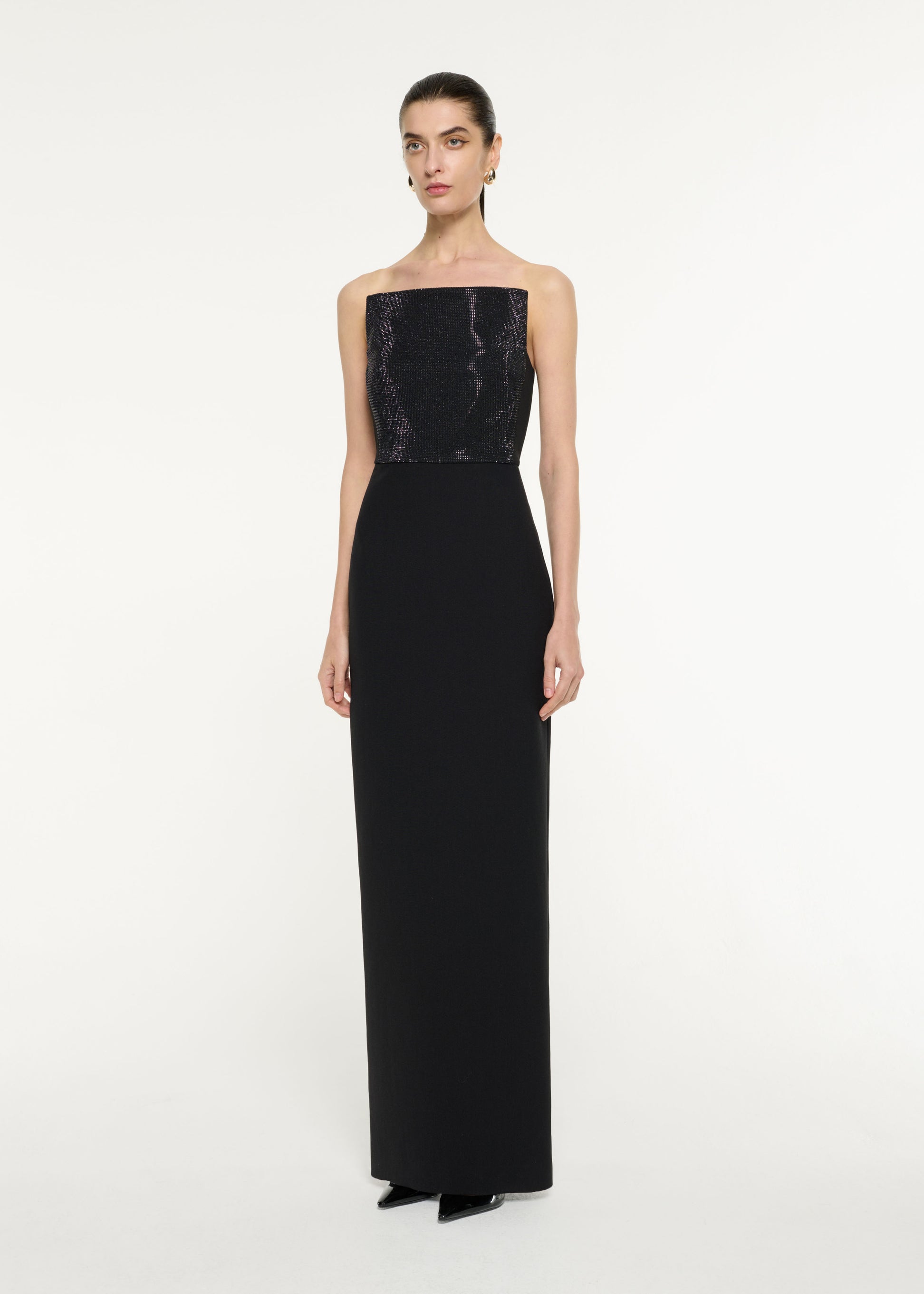 Side view of a model wearing the Diamante Panel Gown in Black