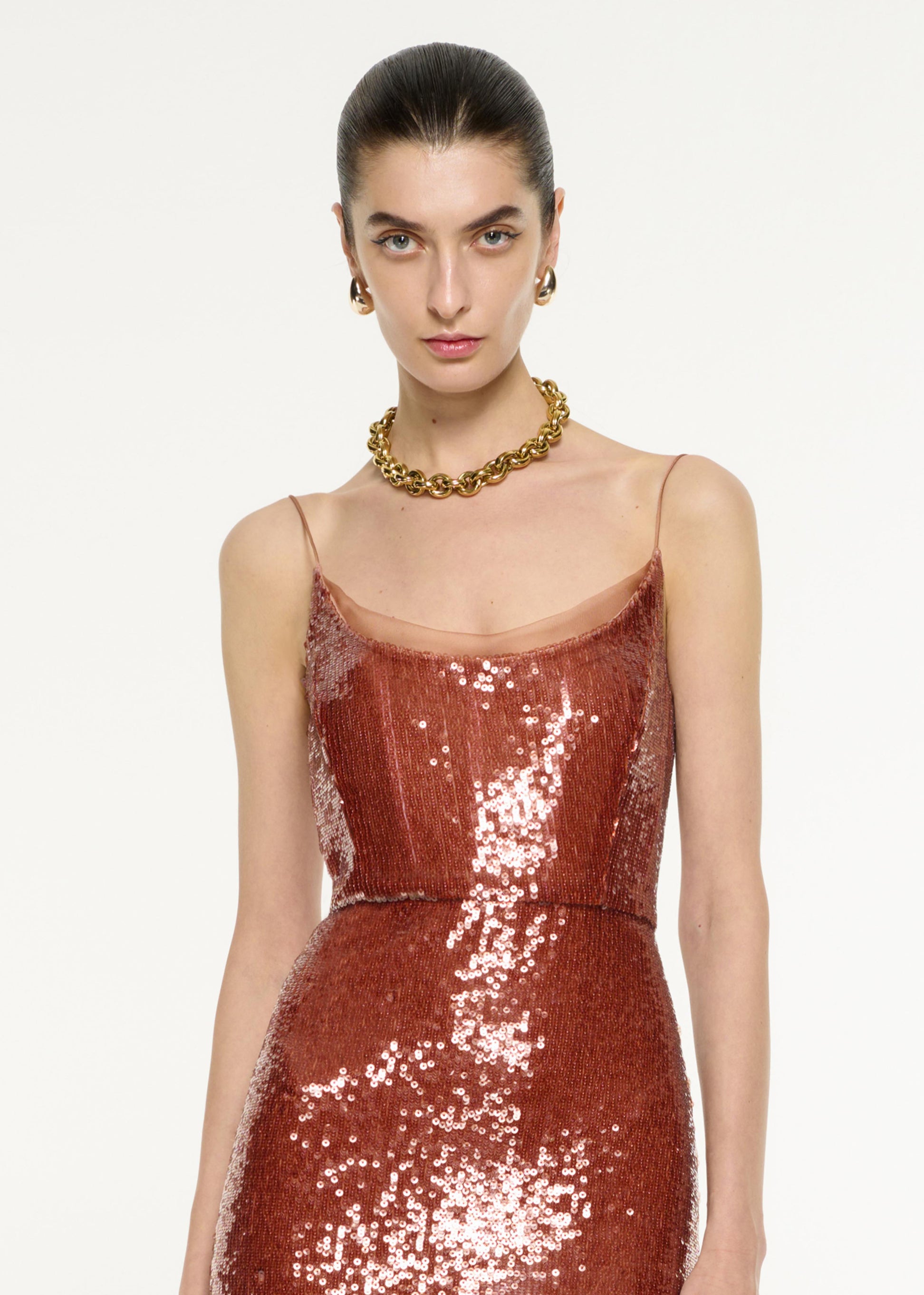 Close up of a model wearing the Sequin Gown in Copper