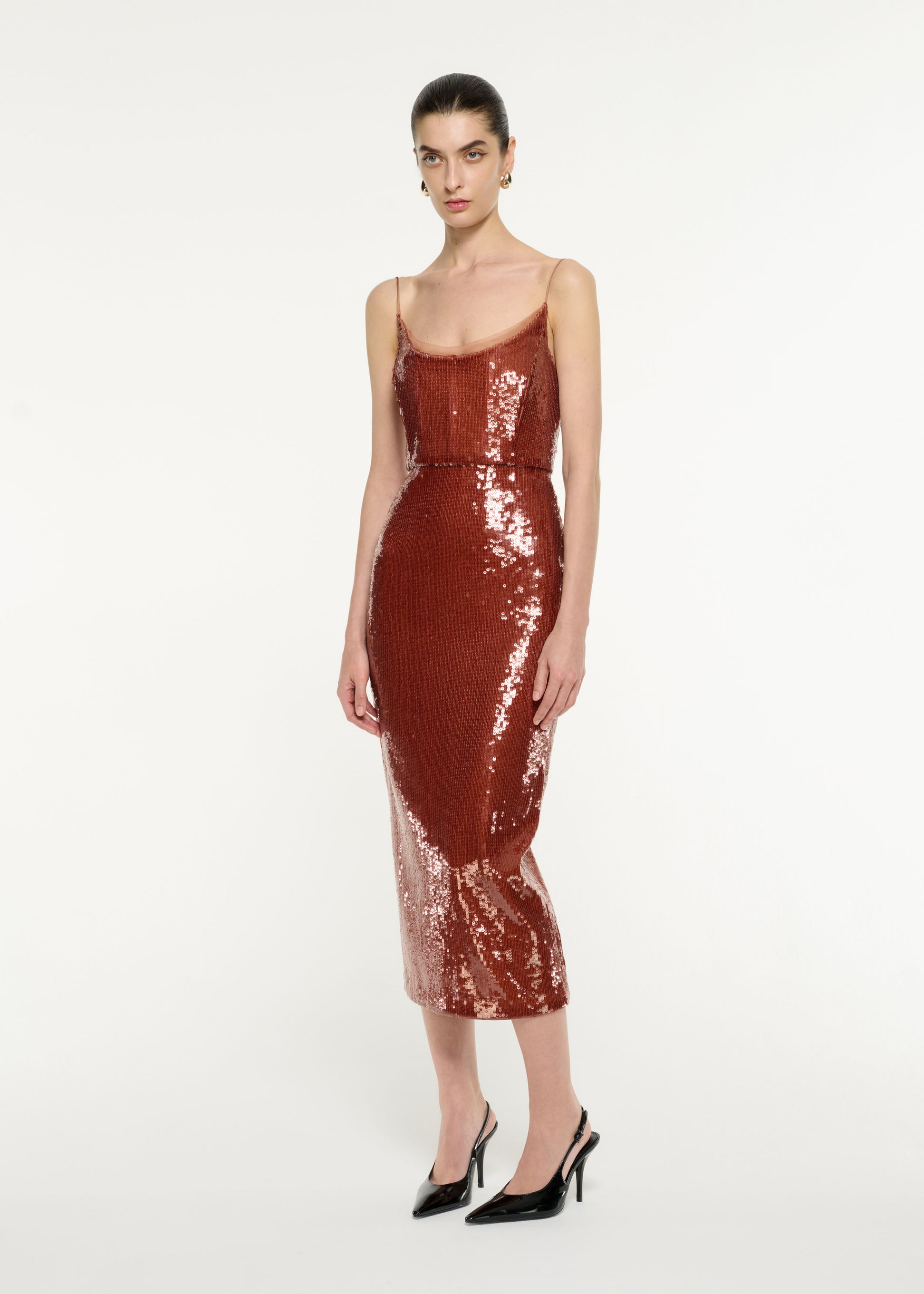 Side view of a model wearing the Sequin Midi Dress in Copper