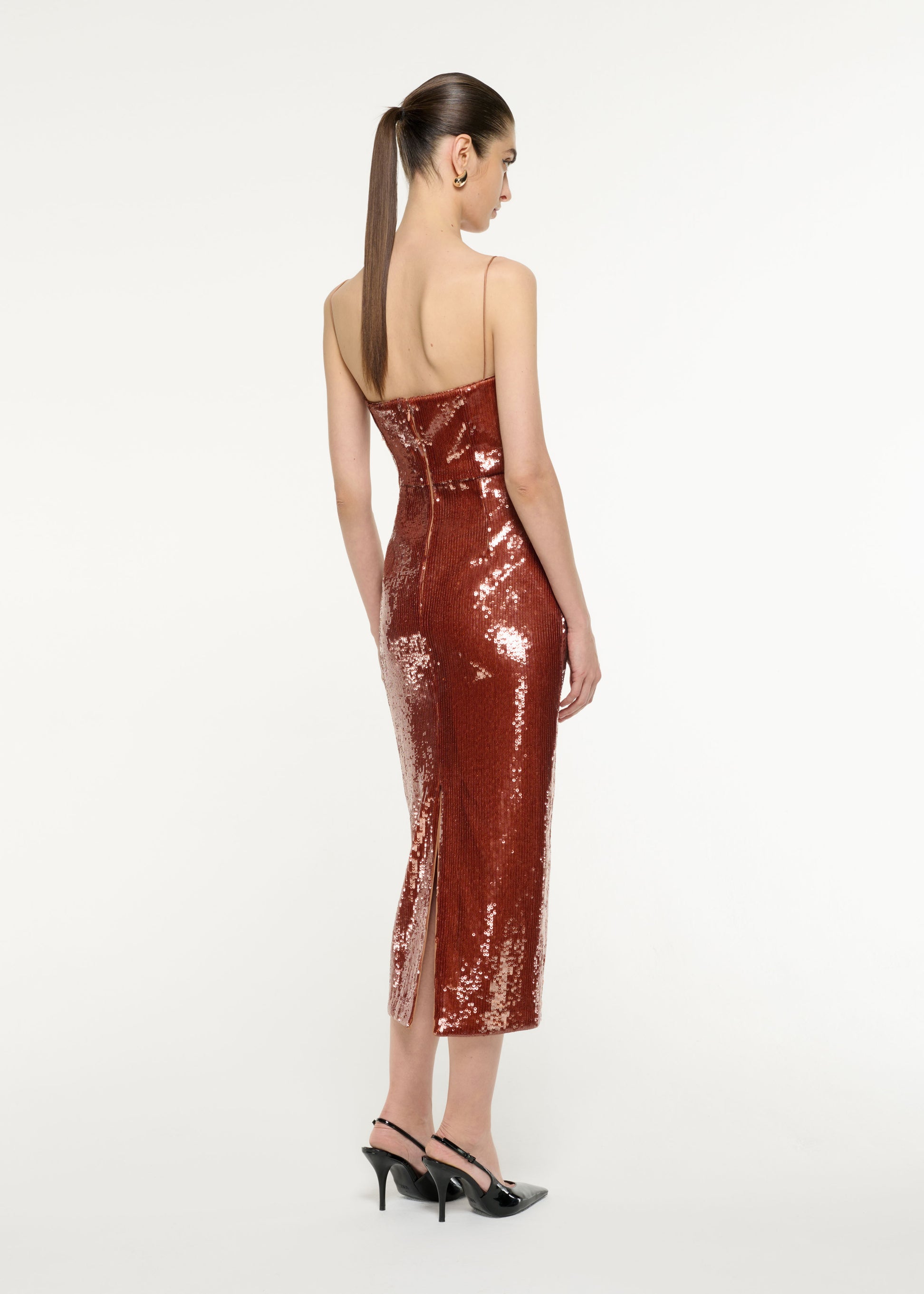 Back view of a model wearing the Sequin Midi Dress in Copper
