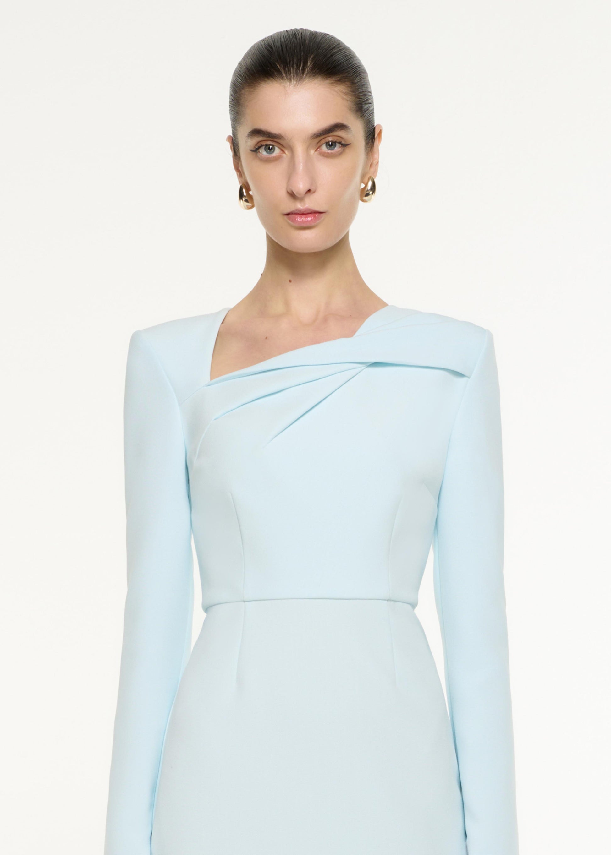 Close up of a model wearing the Tri-fold Drape Midi Dress in Blue