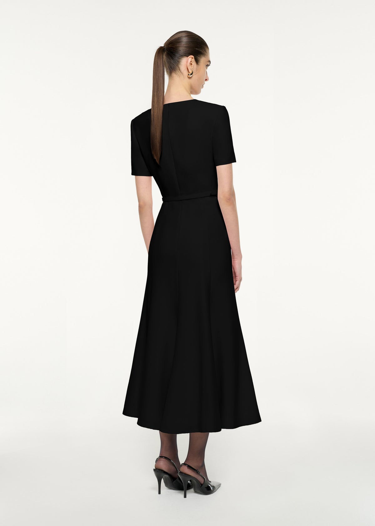 Back view of a model wearing the Short Sleeve Twist Drape Midi Dress in Black