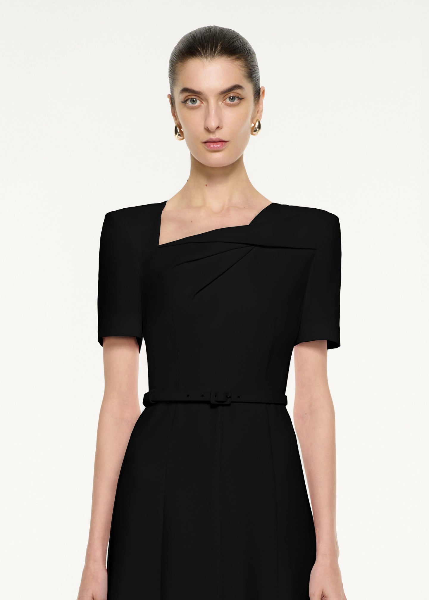 Close up of a model wearing the Short Sleeve Twist Drape Midi Dress in Black