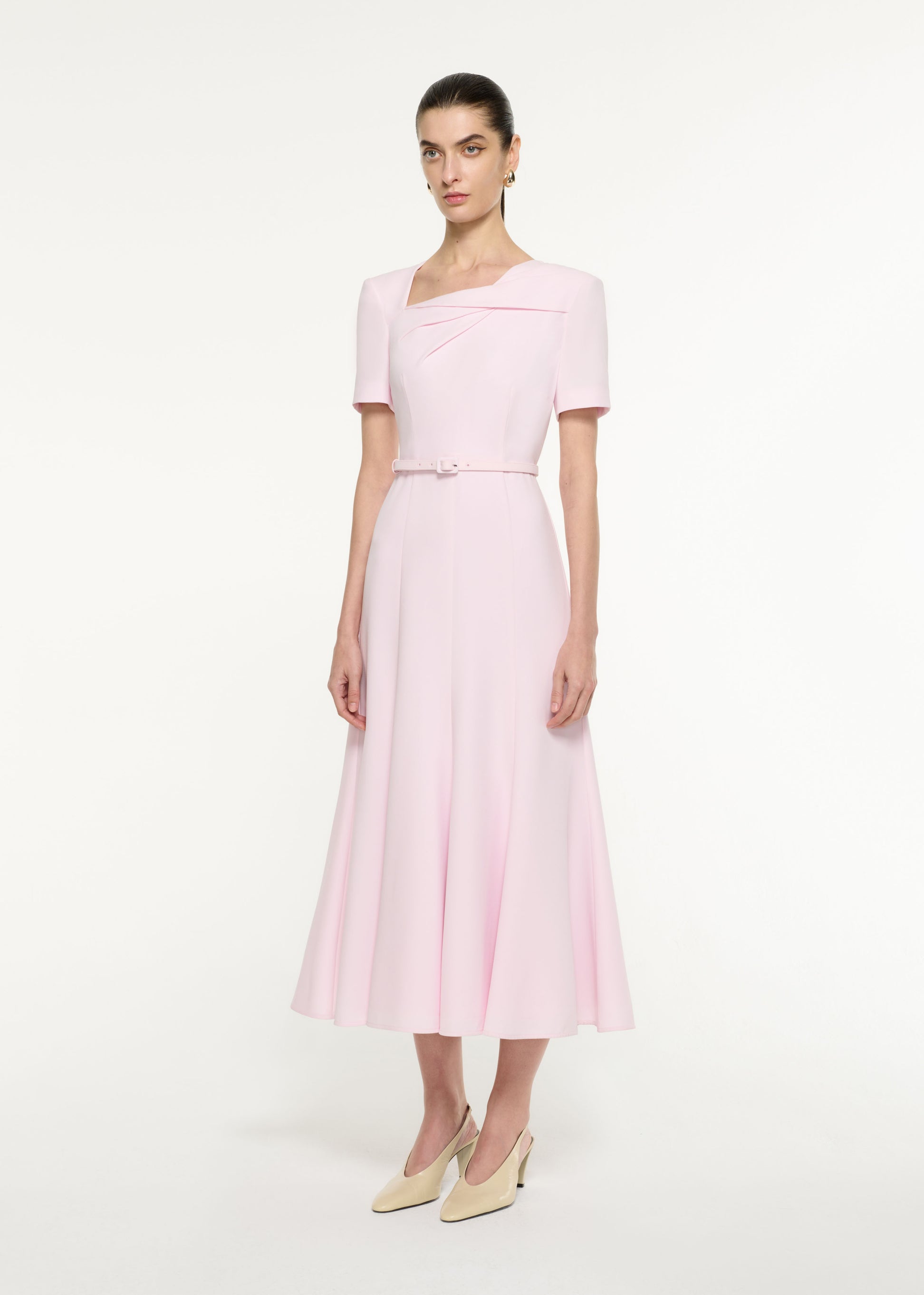 Side view of a model wearing the Tri-fold Drape Midi Dress in Light Pink