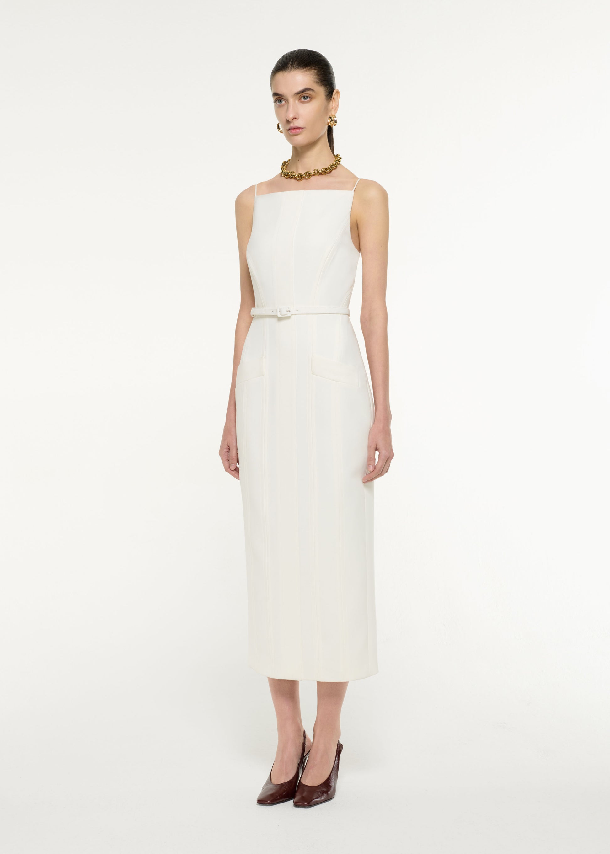Side view of a model wearing the Crepe Tailored Midi Dress in Cream