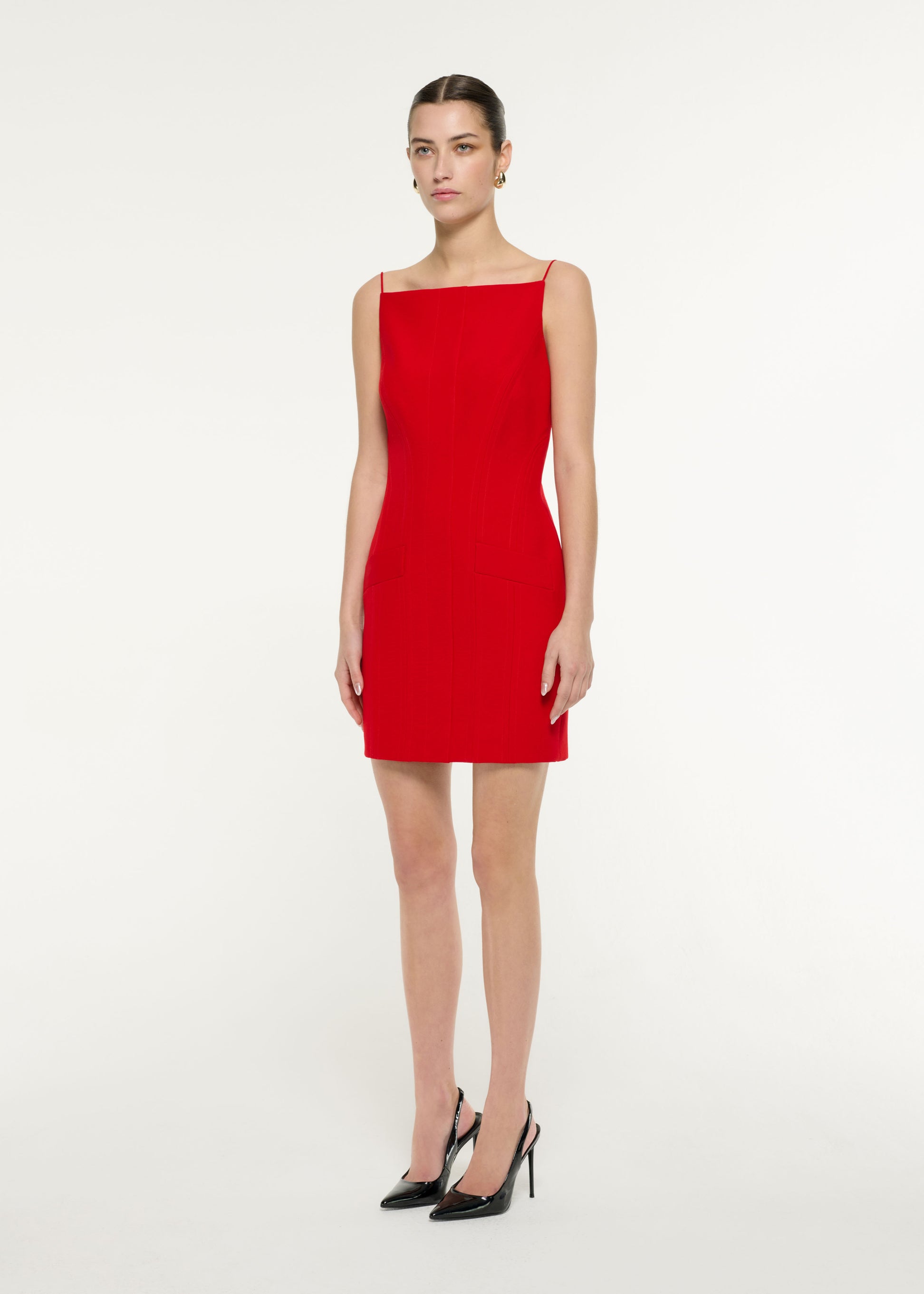 Side view of a model wearing the Crepe Tailored Mini Dress in Red