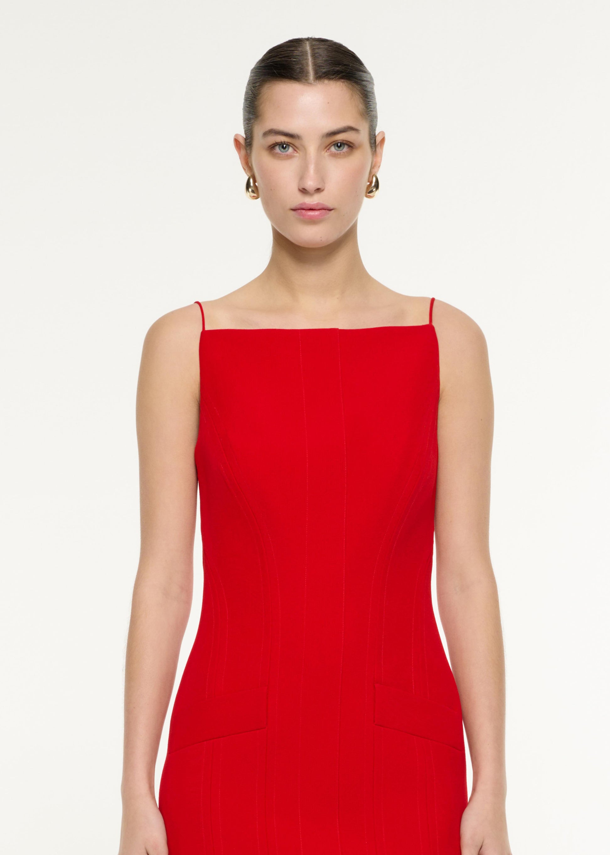 Close up of a model wearing the Crepe Tailored Mini Dress in Red