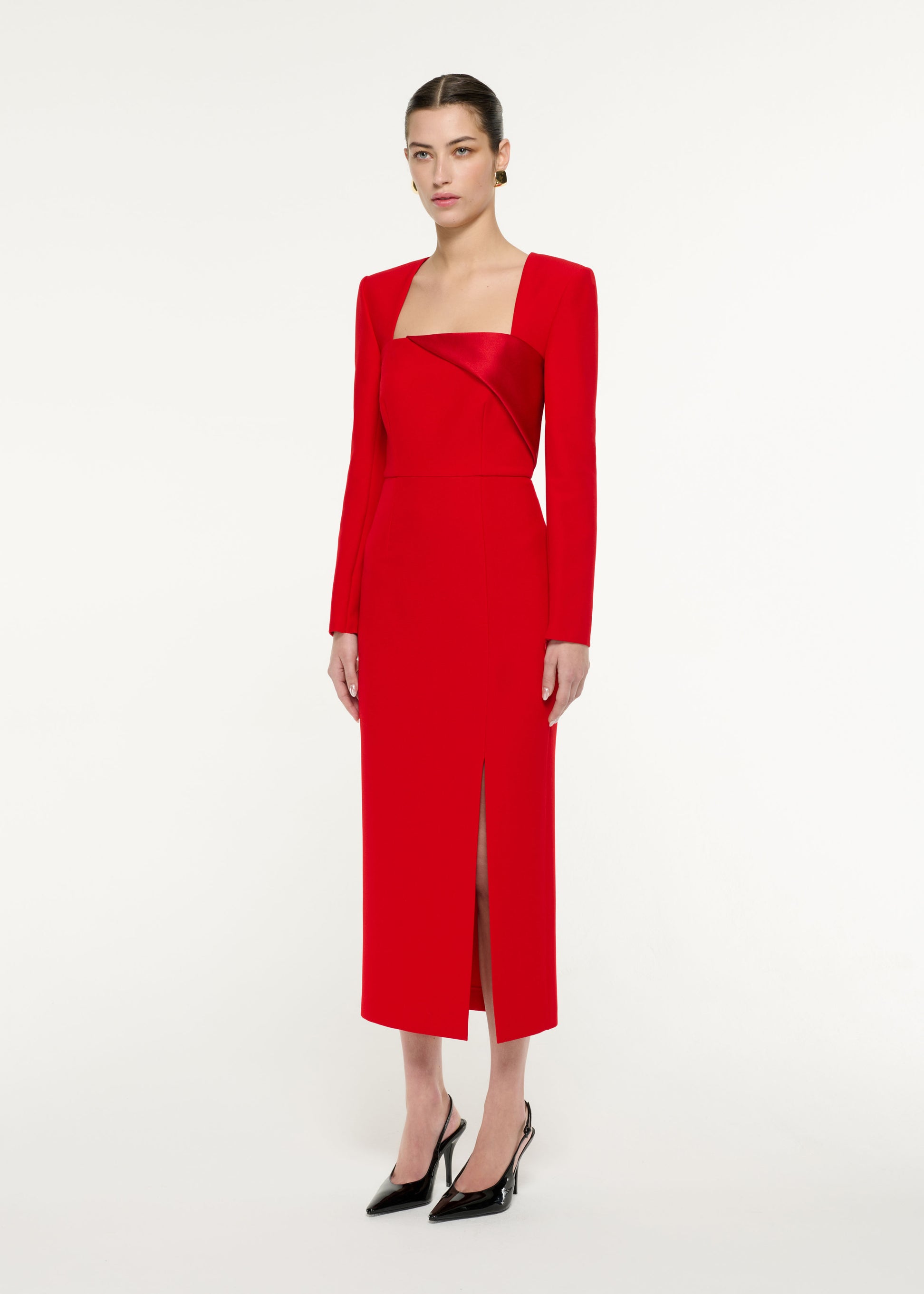 Side view of a model wearing the Diagonal Panel Midi Dress in Red