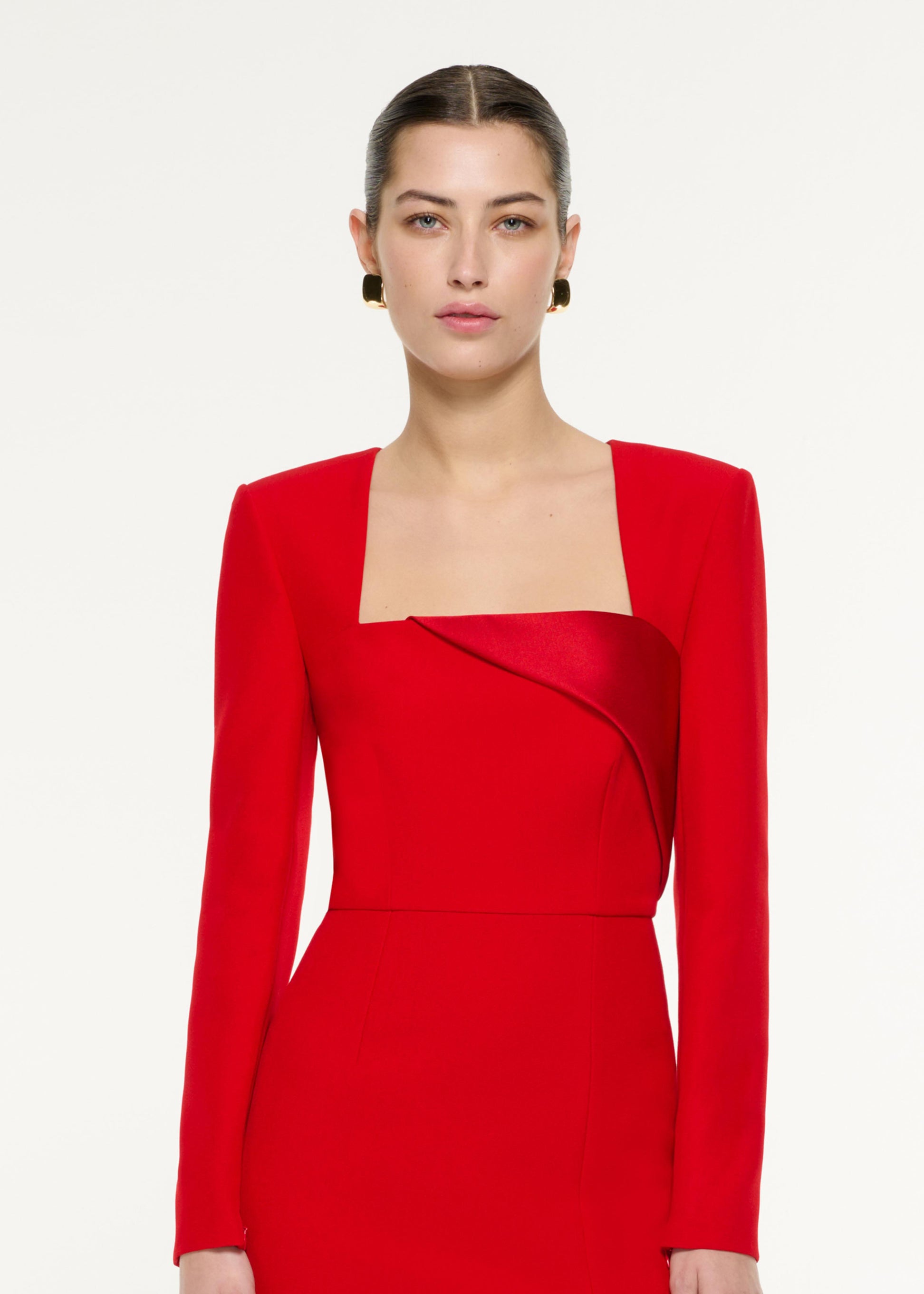 Close up of a model wearing the Diagonal Panel Midi Dress in Red