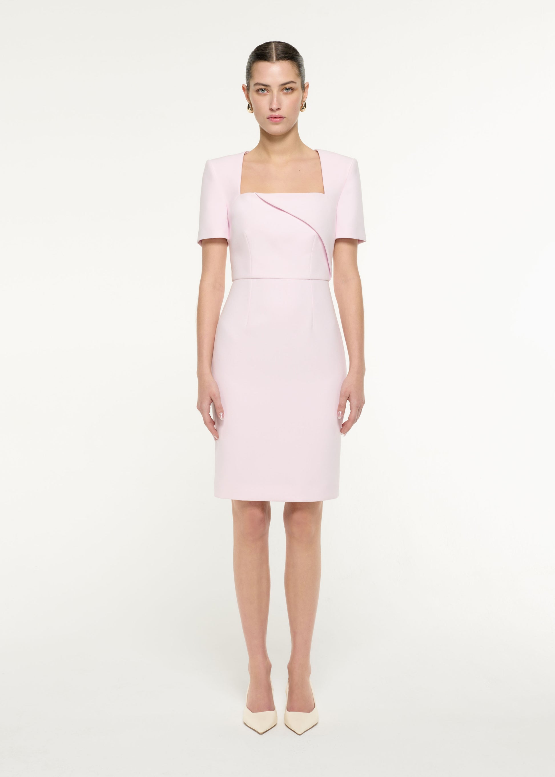 Front view of a model wearing the Diagonal Fold Midi Dress in Light Pink