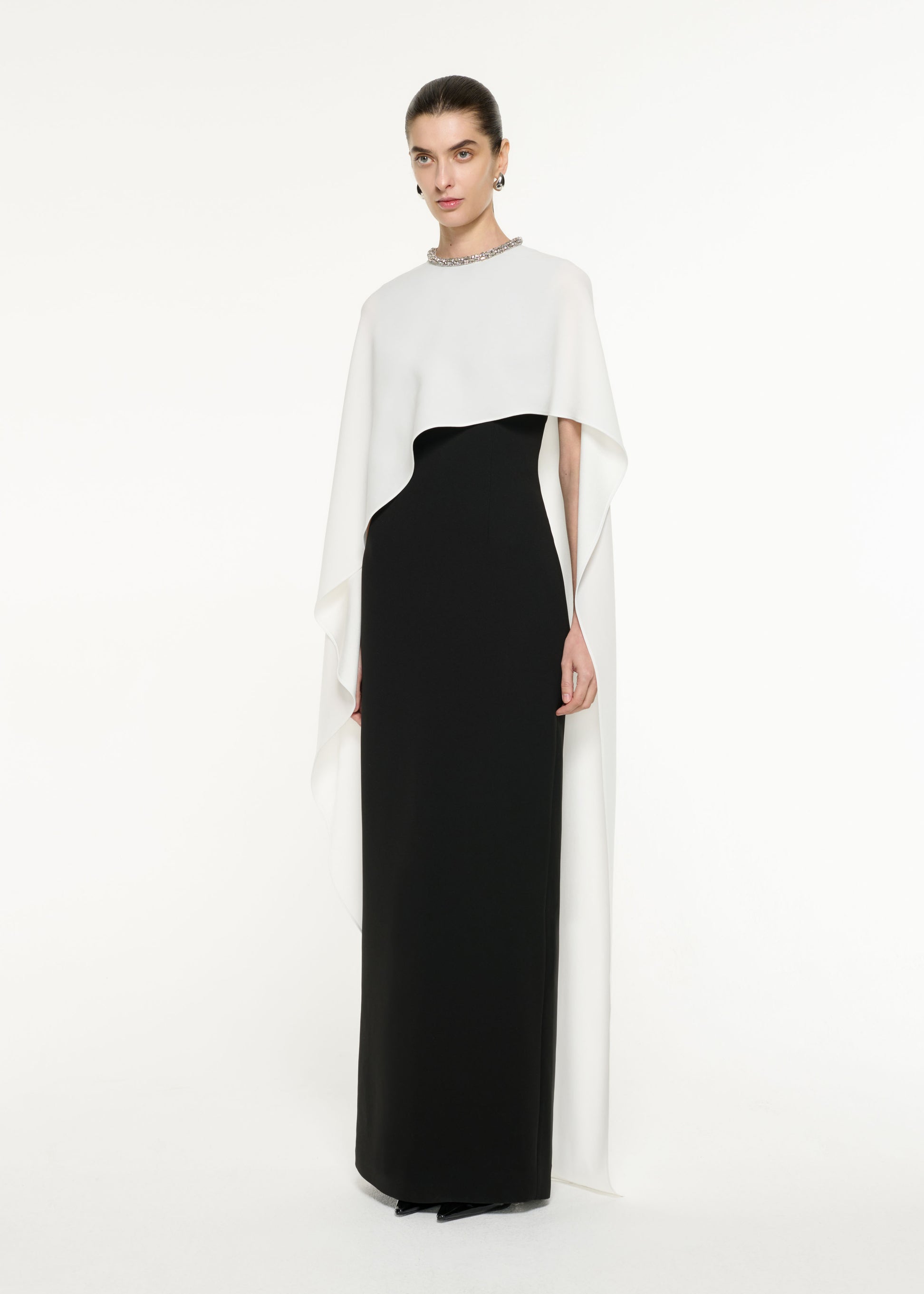 Front view of a model wearing the Satin Crepe Cape Gown in Monocrhome