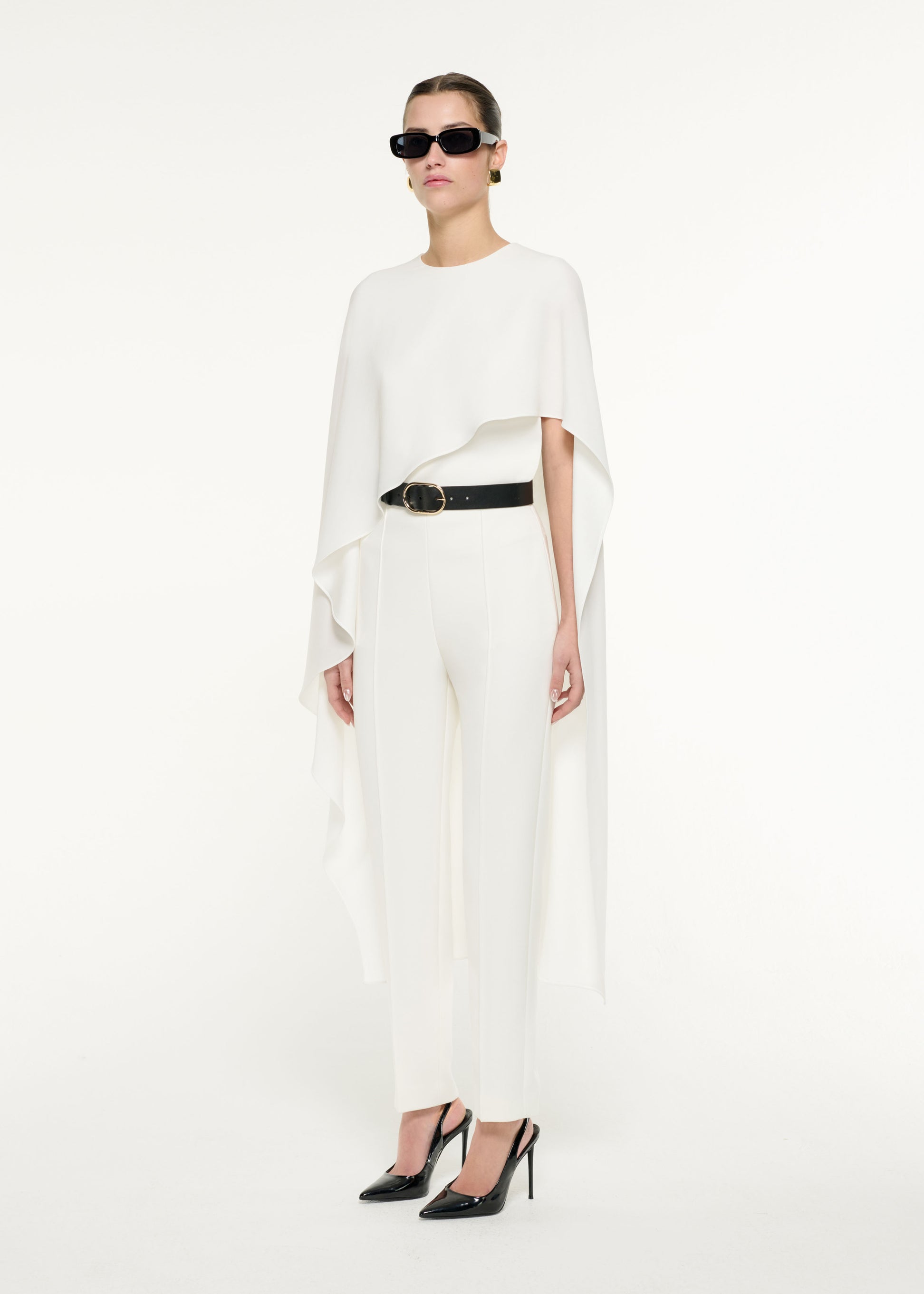 Side view of a model wearing the Satin Crepe Cape Top in White